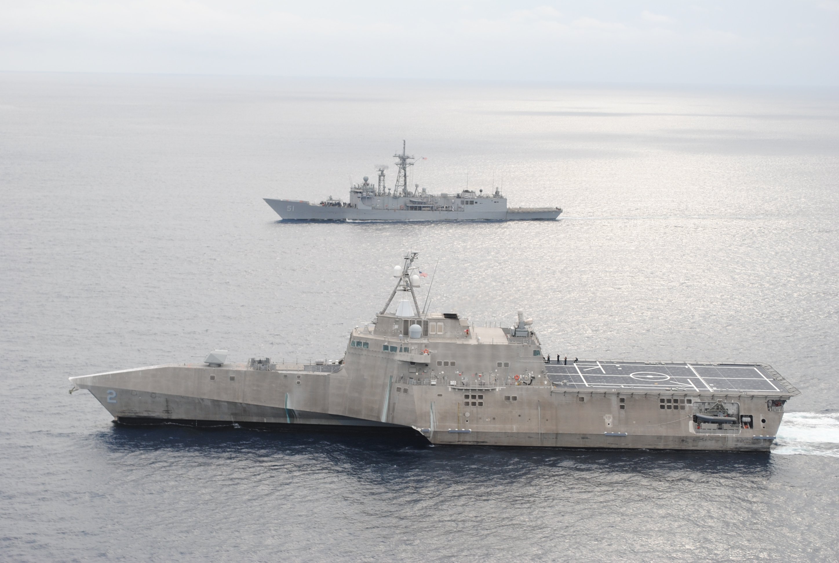 The guided-missile frigate USS Gary (FFG-51), top, and the littoral combat ship USS Independence (LCS-2) conduct a photo exercise off the coast of Central America in January. US Navy photo.