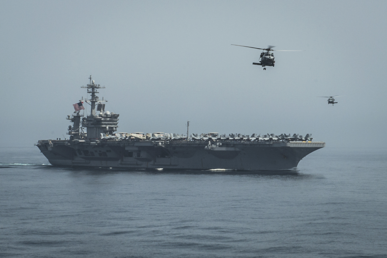 Helicopters fly from the aircraft carrier USS Theodore Roosevelt (CVN-71) on April 13, 2015. US Navy Photo