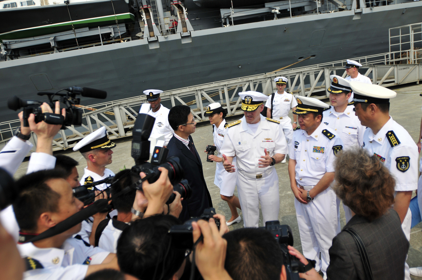 Chinese media document the arrival of Vice Adm. Robert Thomas, commander of U.S. 7th Fleet, during a welcome ceremony in Zhanjiang following the arrival of the U.S. 7th Fleet flagship USS Blue Ridge (LCC 19) on April 20, 2015. US Navy photo.