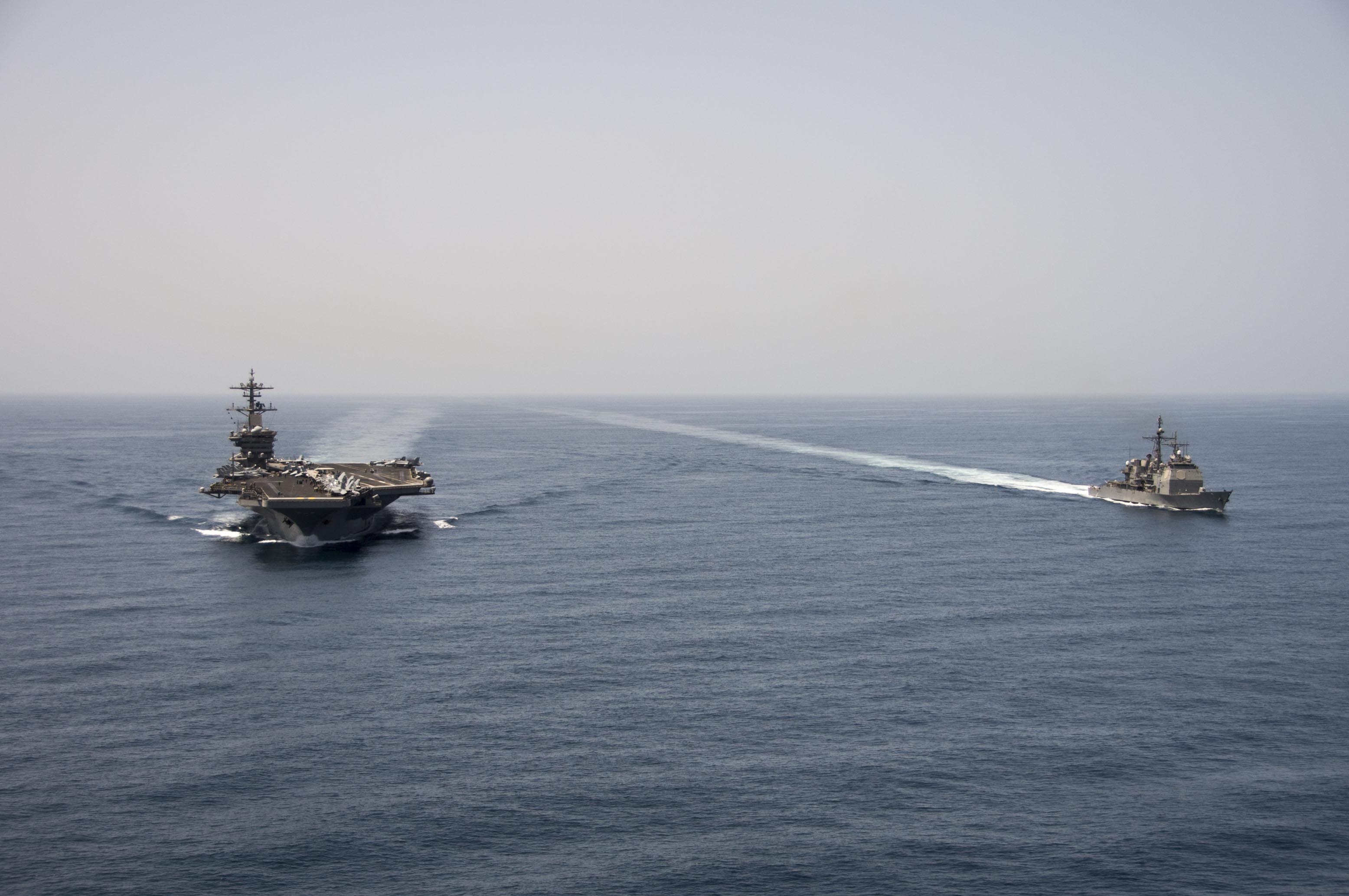 USS Theodore Roosevelt (CVN 71) and the guided-missile cruiser USS Normandy (CG 60) operate in the Arabian Sea on April 21, 2015. US Navy Photo