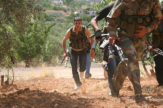 “Justice Brigade” run through an olive grove to avoid Syrian Army snipers as they travel between villages on foot in the northwestern Jabal al-Zawiya area. Freedom House Photo via The Atlantic Council 