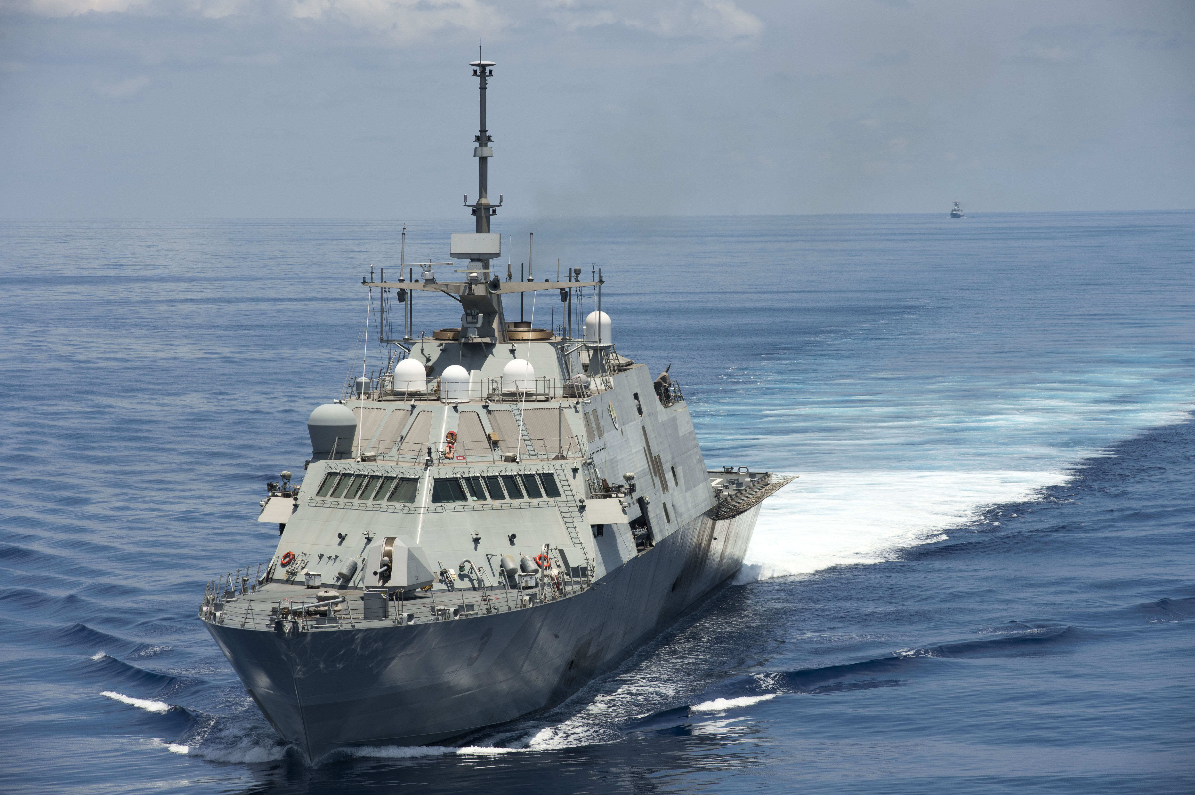 The littoral combat ship USS Fort Worth (LCS 3) conducts patrols in international waters of the South China Sea near the Spratly Islands as the People's Liberation Army-Navy [PLA(N)] guided-missile frigate Yancheng (FFG 546) transits close behind on May 11, 2015. US Navy photo.