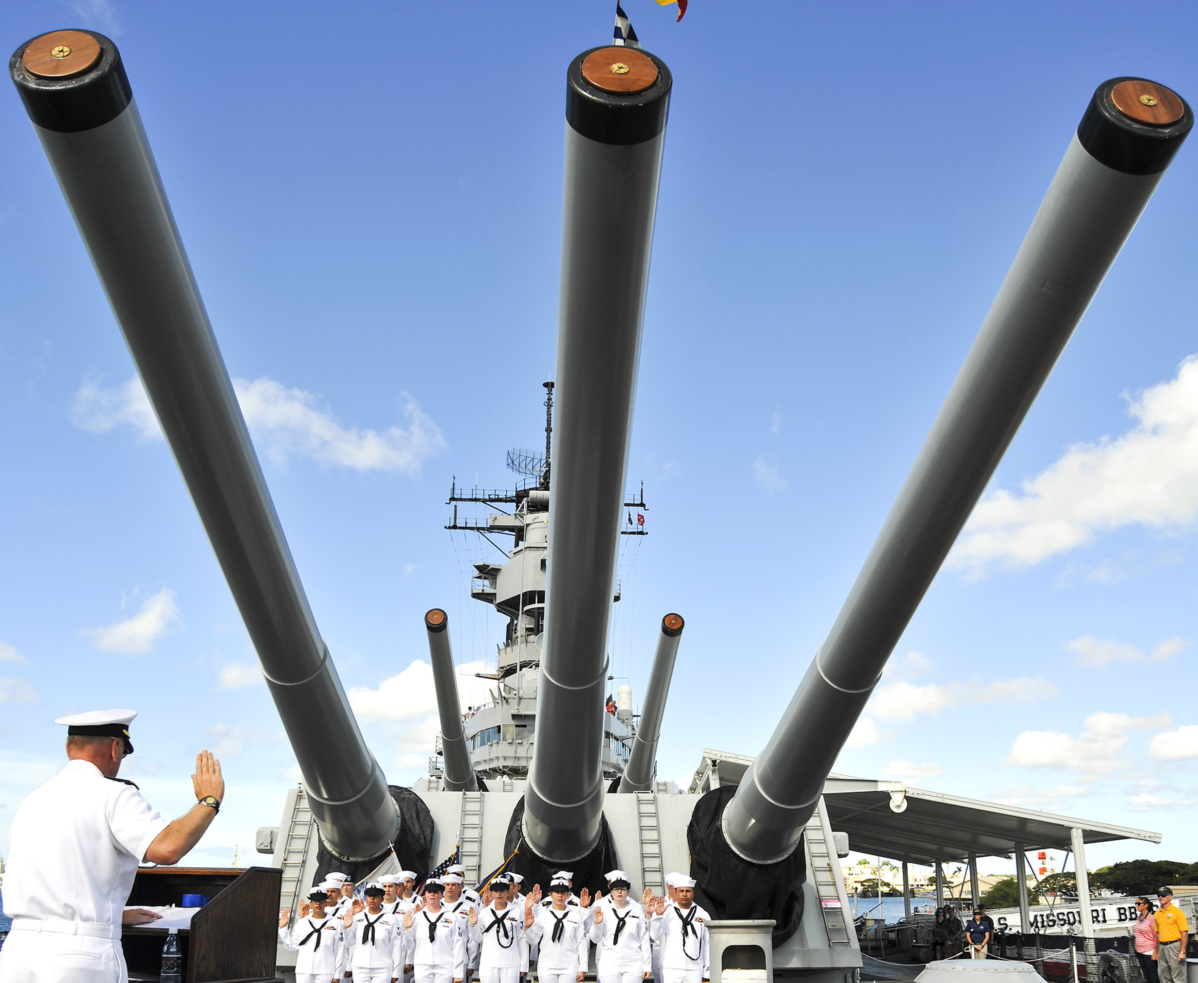 Rear Adm. Rick Williams, commander of Navy Region Hawaii and Naval Surface Group Middle Pacific, serves as reenlisting officer for service members aboard the Battleship Missouri Memorial on Ford Island at Joint Base Pearl Harbor-Hickam on July 4, 2014. US Navy Photo