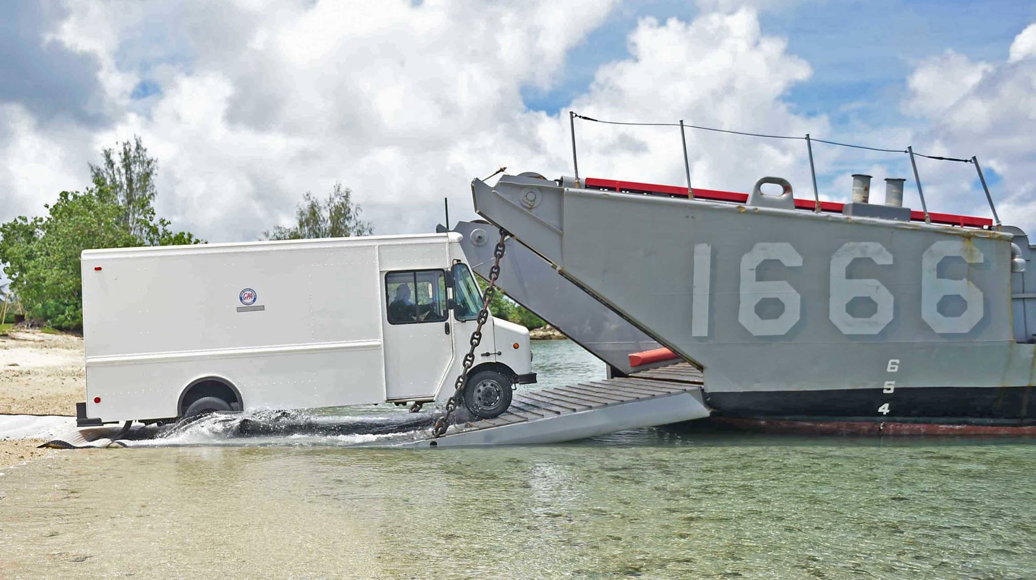 A civilian power generating truck is driven from a Guam beach onto the deck of Landing Craft Utility (LCU) 1666, attached to Naval Beach Unit (NBU) 7, for disaster relief efforts in Saipan after Typhoon Soudelor. US Navy photo via US Naval Base Guam Facebook page.