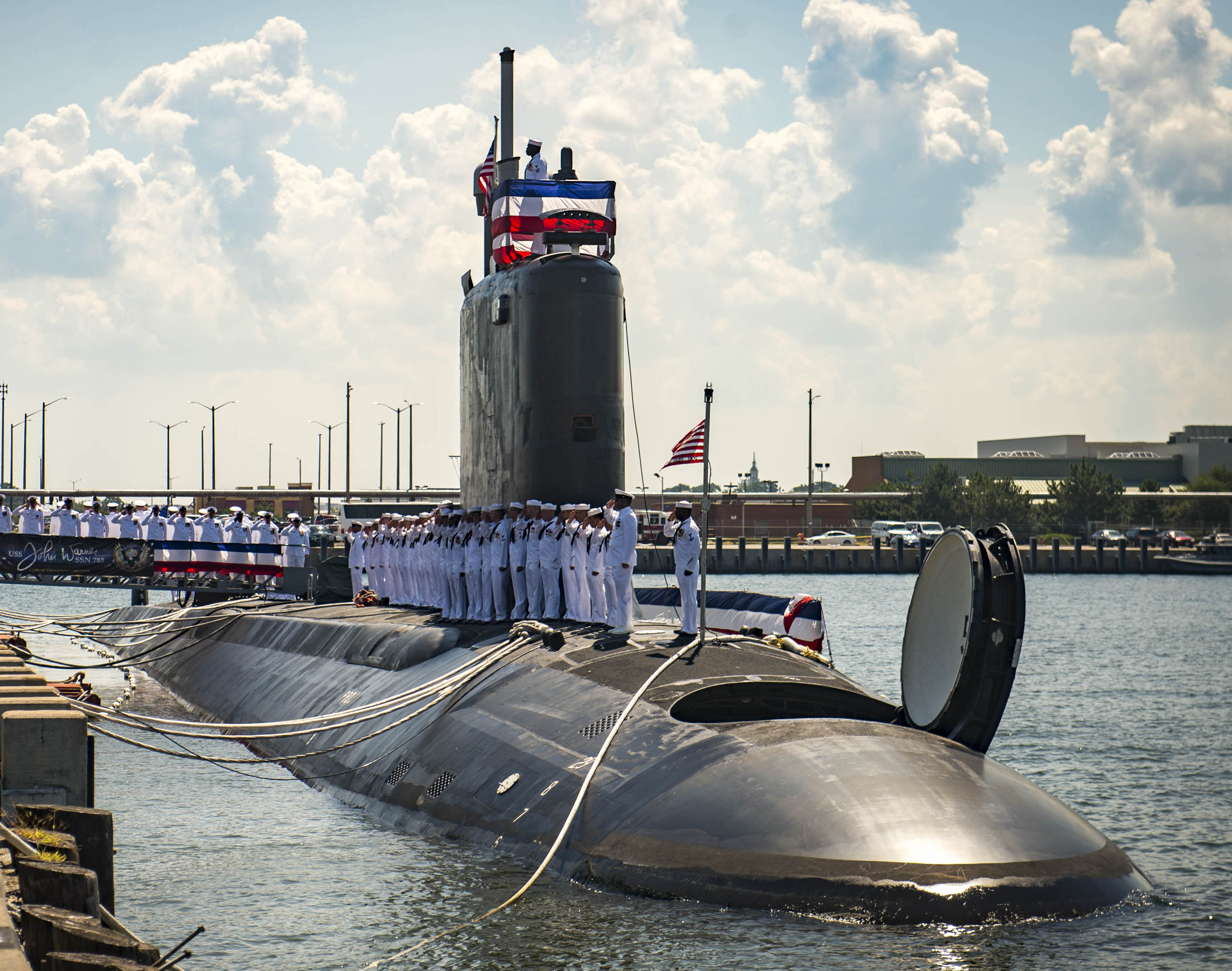 Sailors man the rails as they bring the ship to life during the commissioning ceremony for the Virginia-class attack submarine USS John Warner (SSN-785) on Aug 1, 2015. US Navy Photo