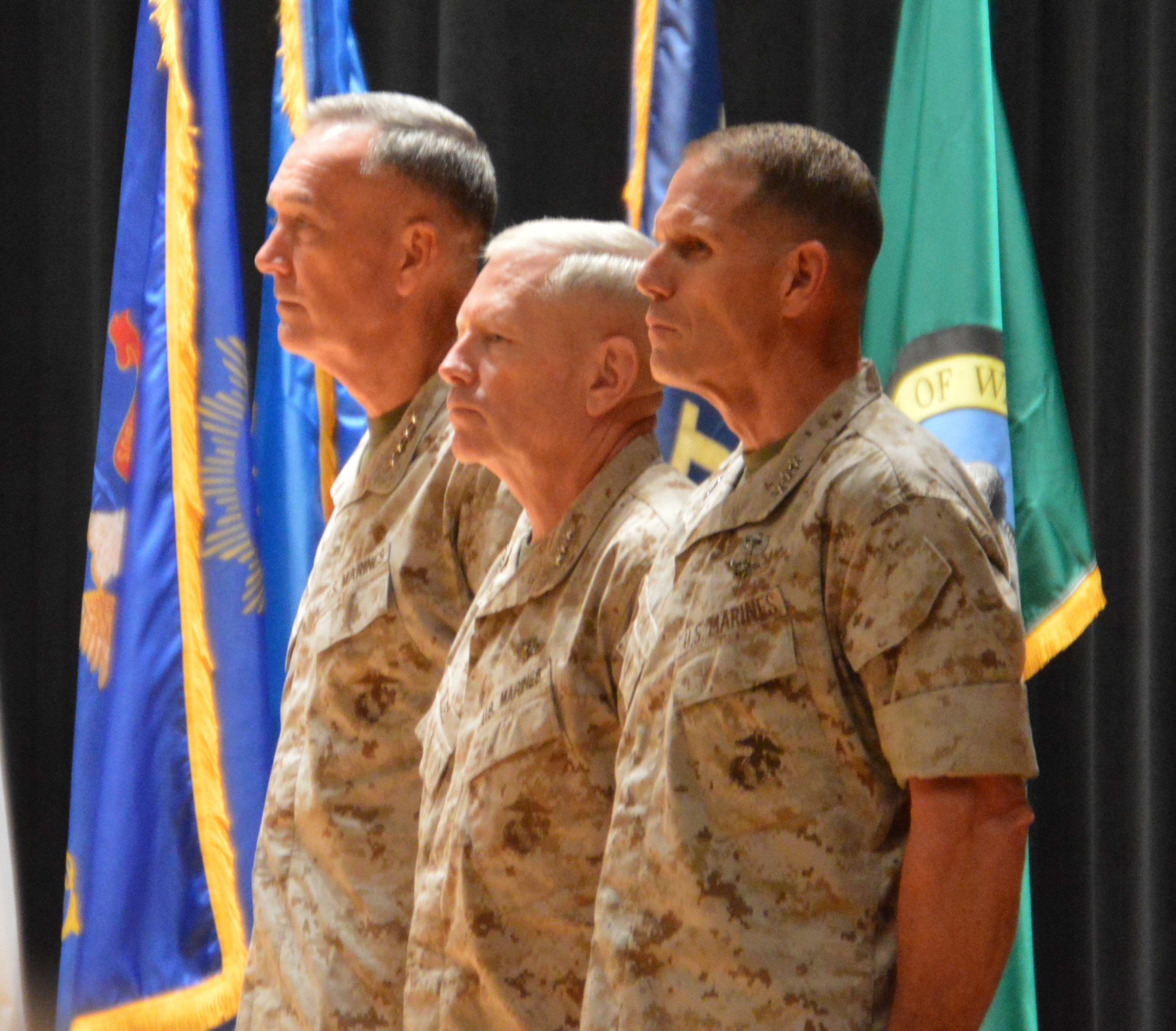 Lt. Gen. Robert Walsh (right) takes command of the Marine Corps Combat Development Command from retiring Lt. Gen. Kenneth Glueck (center) in an Aug. 20 ceremony at Marine Corps Base Quantico, Va. USNI News photo.