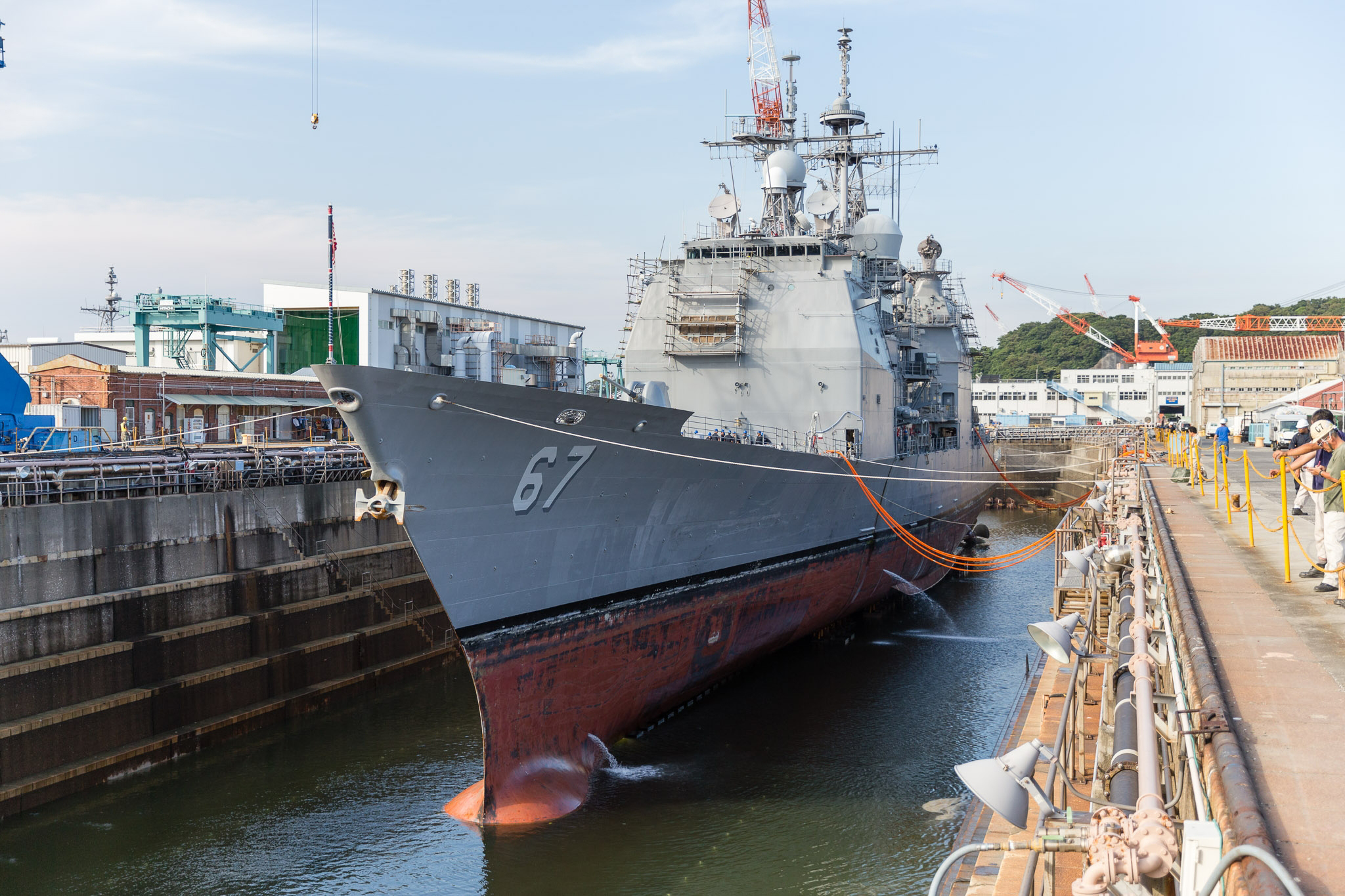 Water is drained from a dry dock at U.S. Naval Ship Repair Facility and Japan Regional Maintenance Center (SRF JRMC) Yokosuka preparing the Ticonderoga-class guided-missile cruiser USS Shiloh (CG 67) for a scheduled maintenance availability in July 2015. US Navy photo.