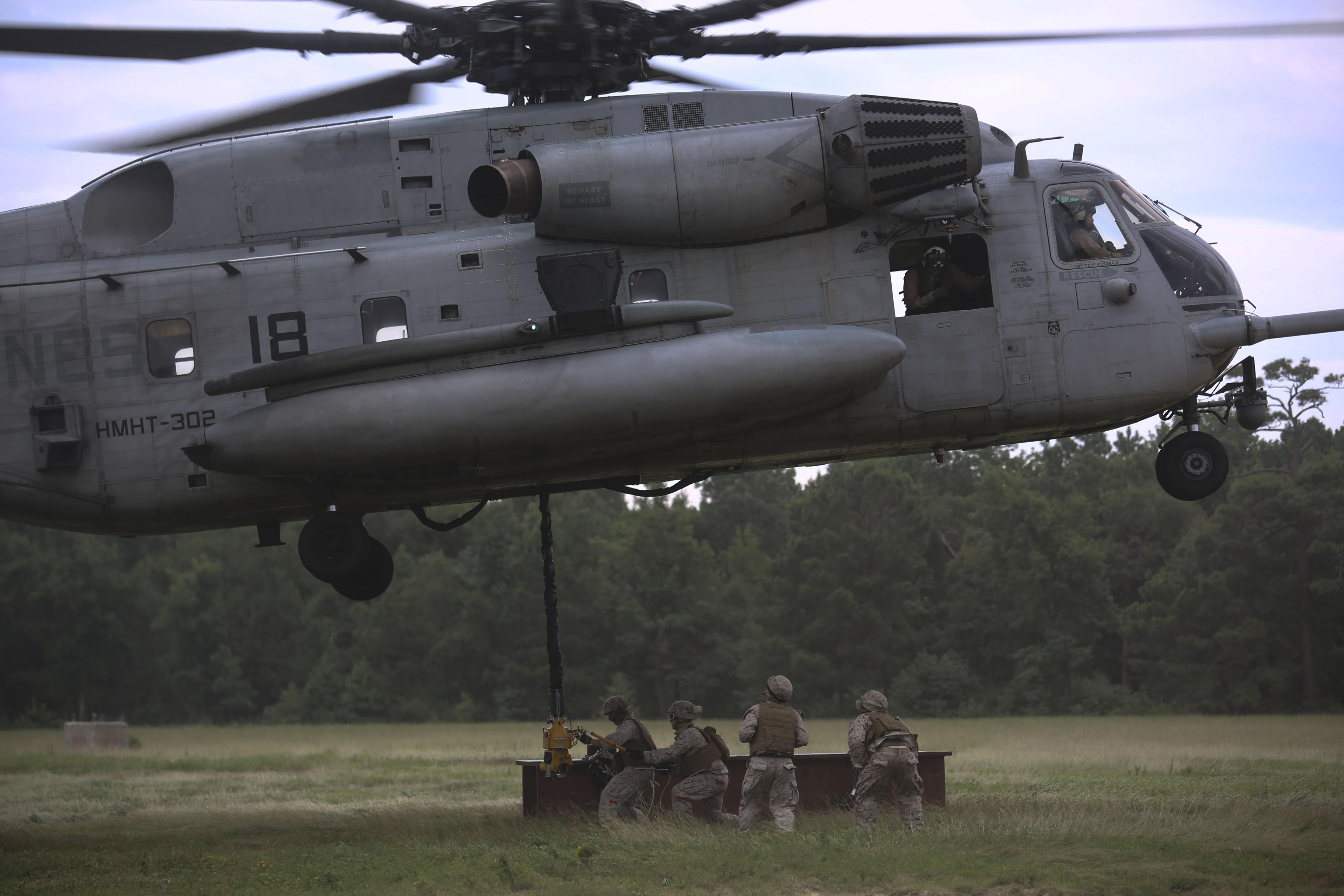 Marines with 2nd Transportation Support Battalion prepare to attach an 8,500-pound high beam to a pintle hook beneath a CH-53E Super Stallion during an external lift exercise aboard Camp Lejeune, N.C. on Aug. 25, 2015. US Marine Corps Photo