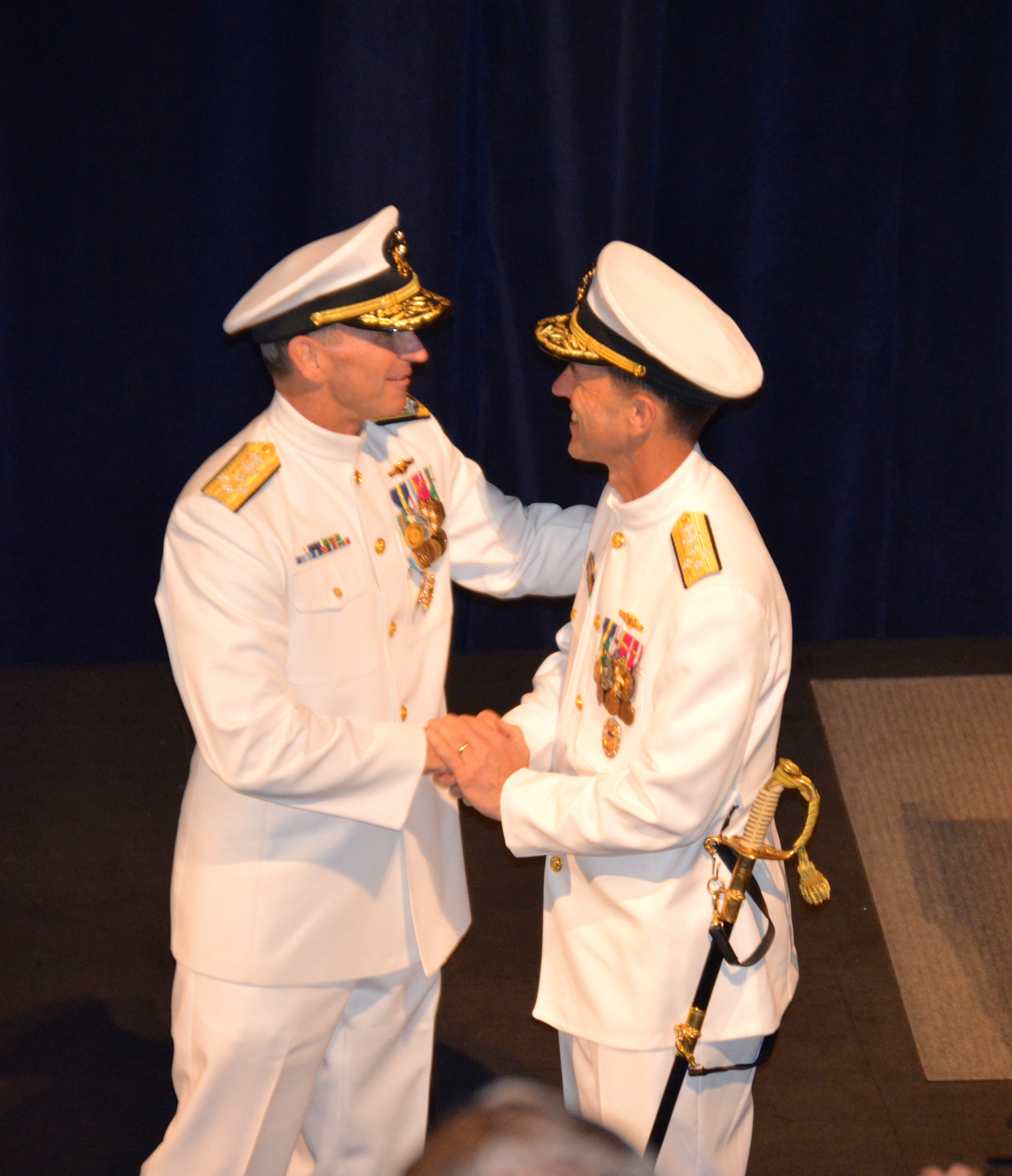 Outgoing Chief of Naval Operations Adm. Jonathan Greenert, left, and incoming CNO Adm. John Richardson, right, congratulate each other during the change of command ceremony. USNI News photo.