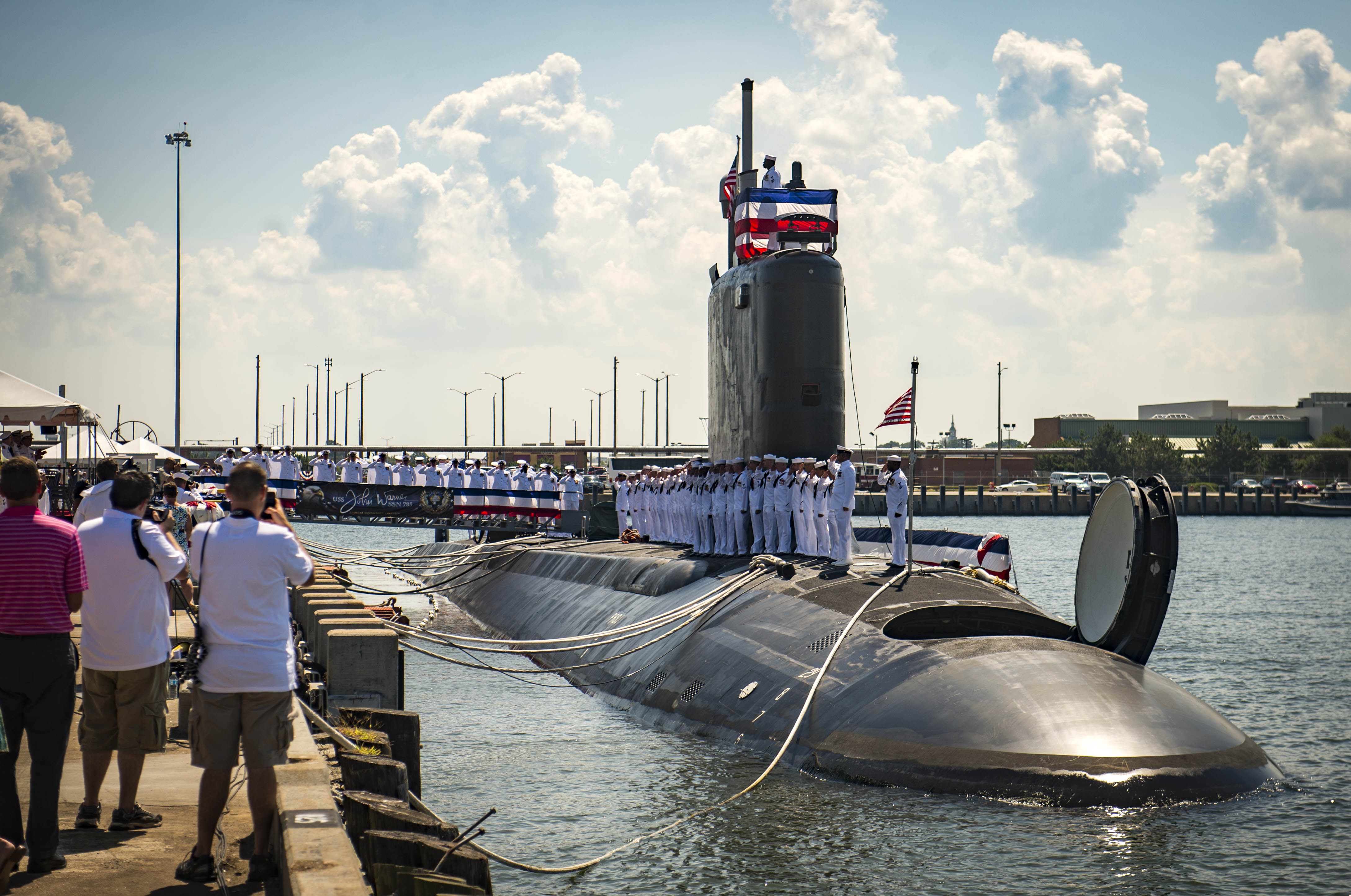 Sailors man the rails as they bring the ship to life during the commissioning ceremony for the Virginia-class attack submarine USS John Warner (SSN-785) at Naval Station Norfolk on Aug. 1, 2015. US Navy photo.