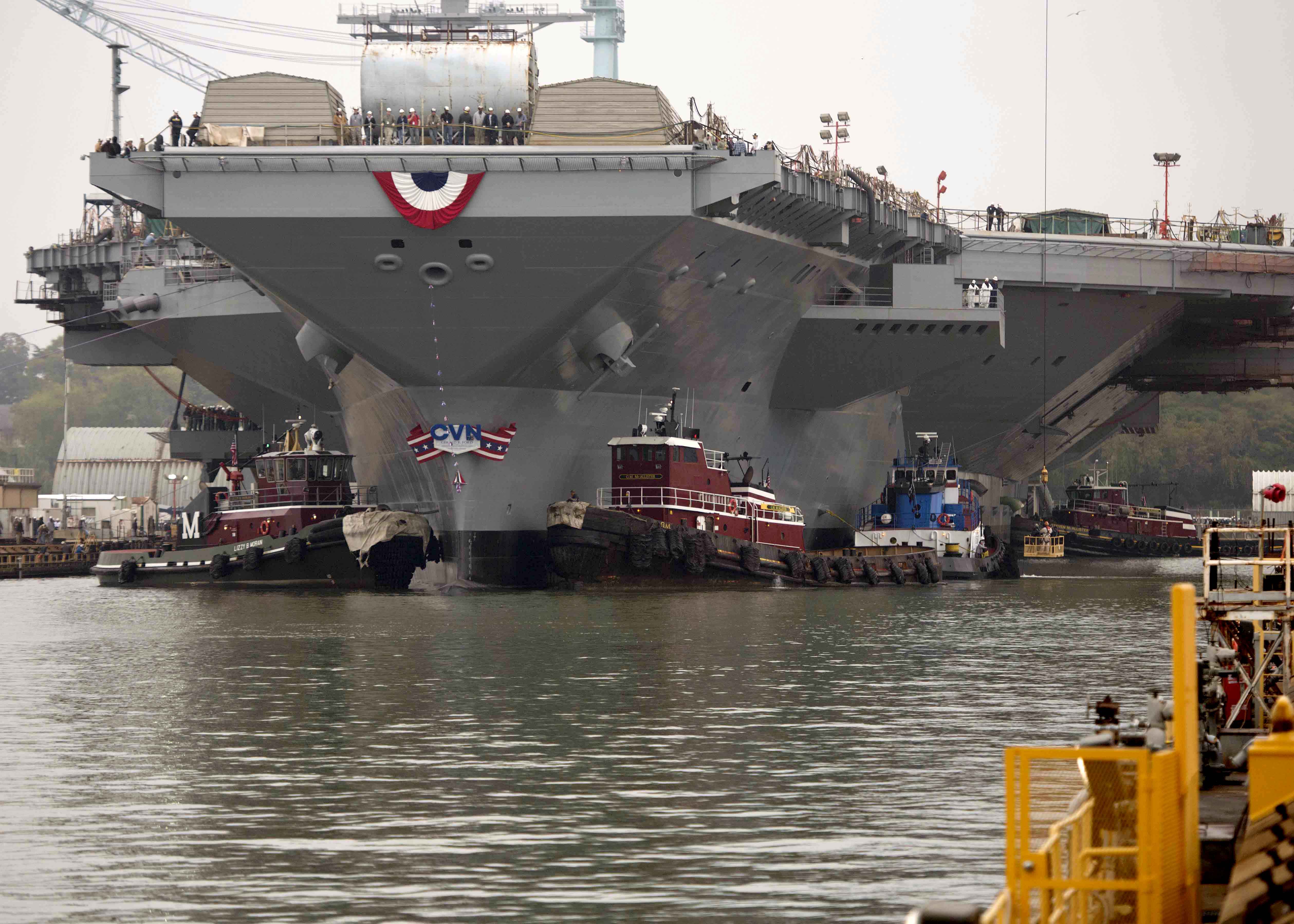 he aircraft carrier Gerald R. Ford (CVN 78) gets underway, beginning the ship’s launch and transit to Newport News Shipyard pier 3 for the final stages of construction and testing in November 2013. US Navy photo.