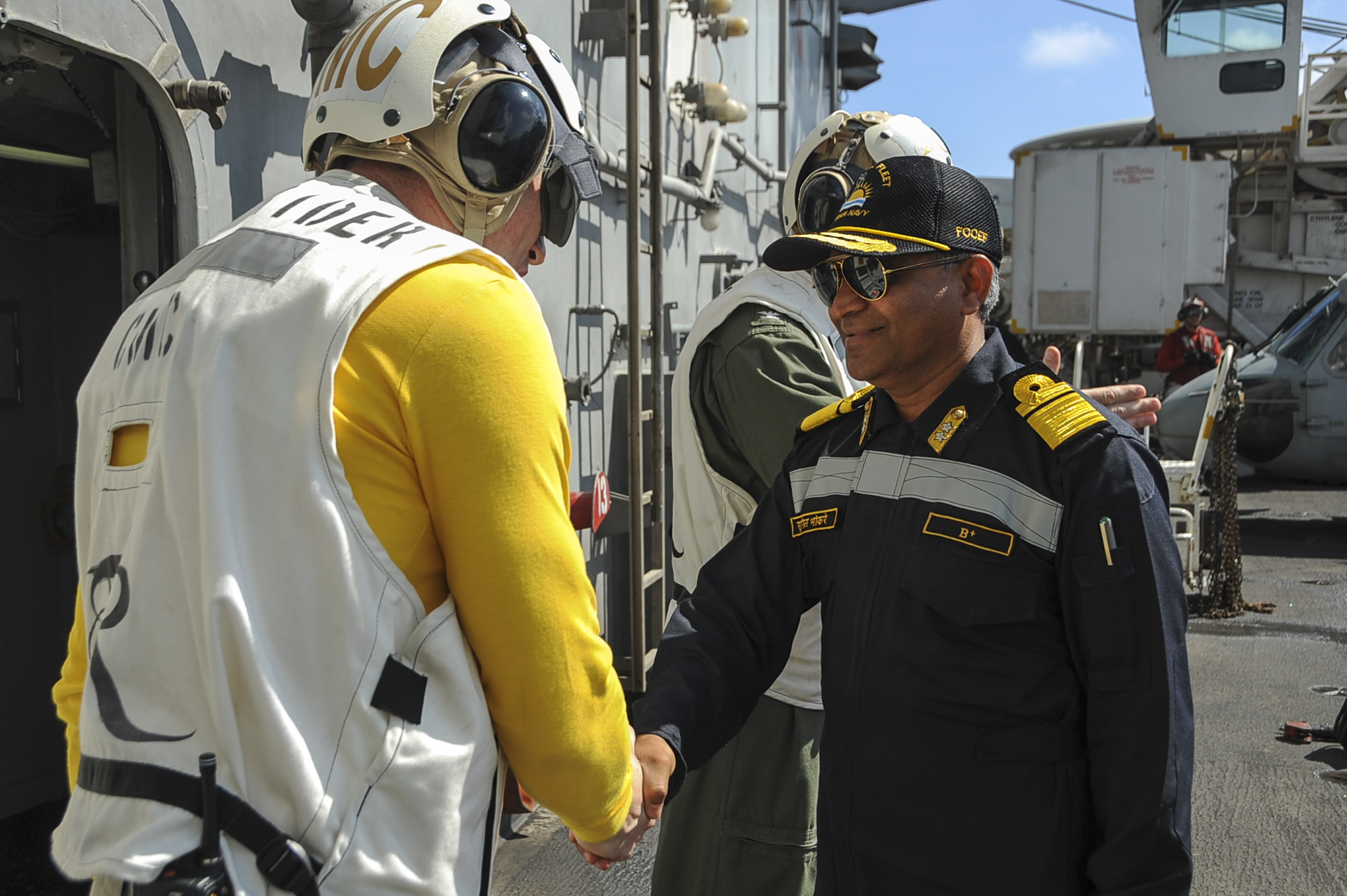 Command master chief of the aircraft carrier USS Theodore Roosevelt (CVN-71), greets Rear Adm. SV Bhokare, Flag Officer Commanding Eastern Fleet, Indian Navy as part of Exercise Malabar 2015. US Navy Photo