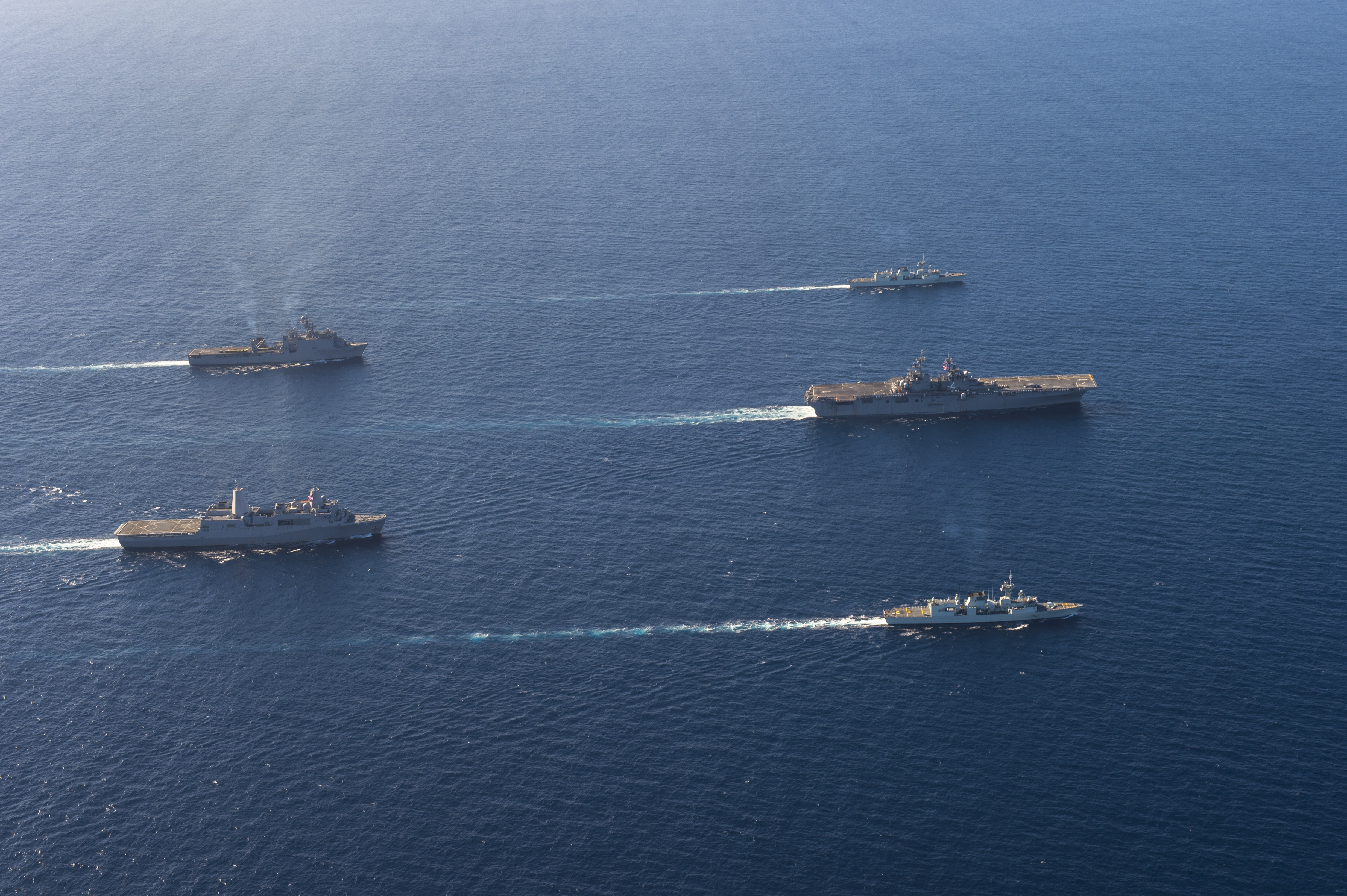 The Boxer Amphibious Ready Group (ARG), composed of amphibious assault ship USS Boxer (LHD 4), amphibious transport dock ship USS New Orleans (LPD 18), dock landing ship USS Harpers Ferry (LSD 49) along with HMCS Vancouver (FF 331) and HMCS Calgary (FF 335) steam in formation on Nov. 5, 2015. US Navy photo.
