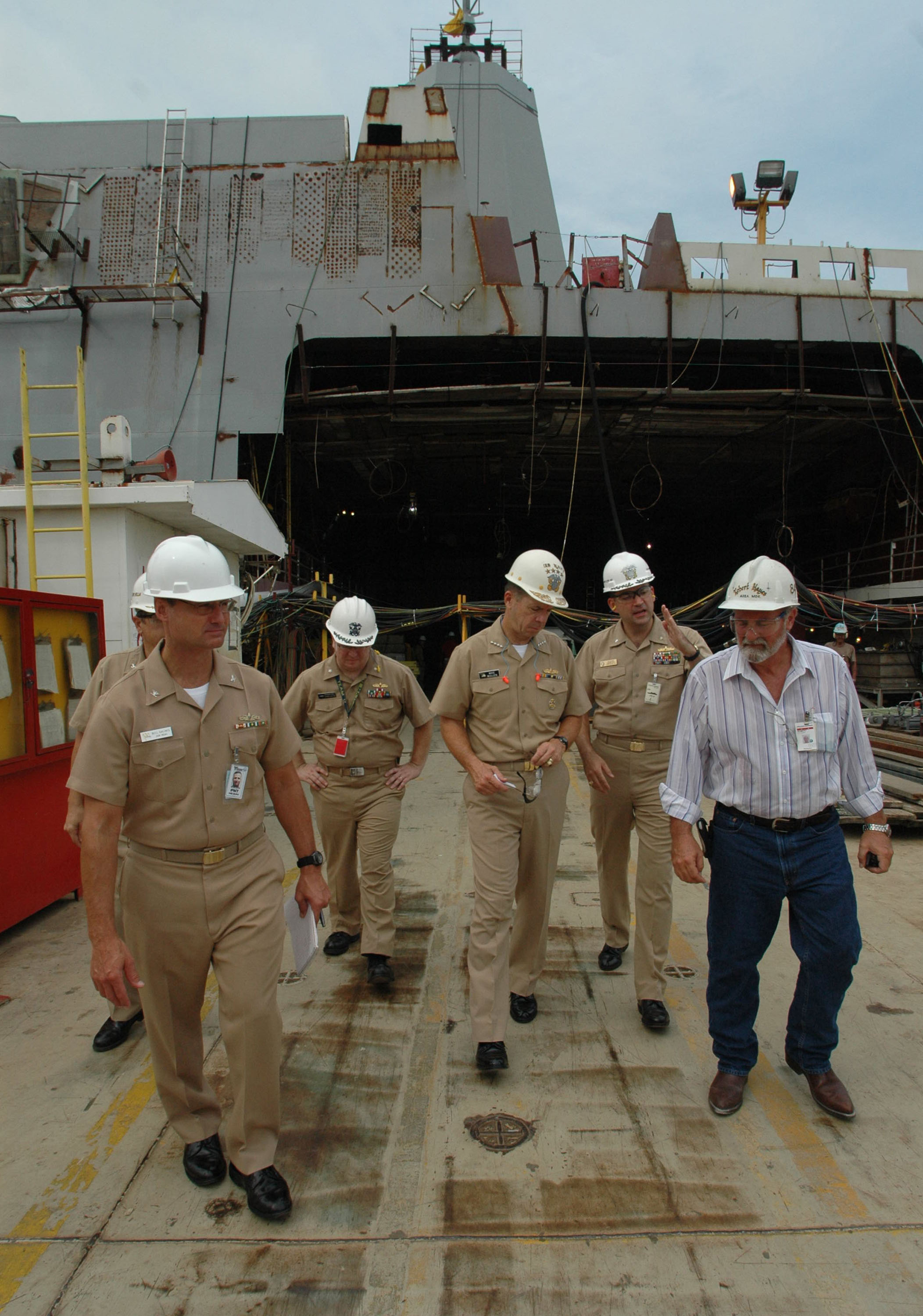 Chief of Naval Operations Adm. Mike Mullen, center, listens to Cmdr. Brad Skillman, the prospective Commanding Officer of Pre-Commissioning Unit New Orleans (LPD-18 ) in 2005. US Navy 