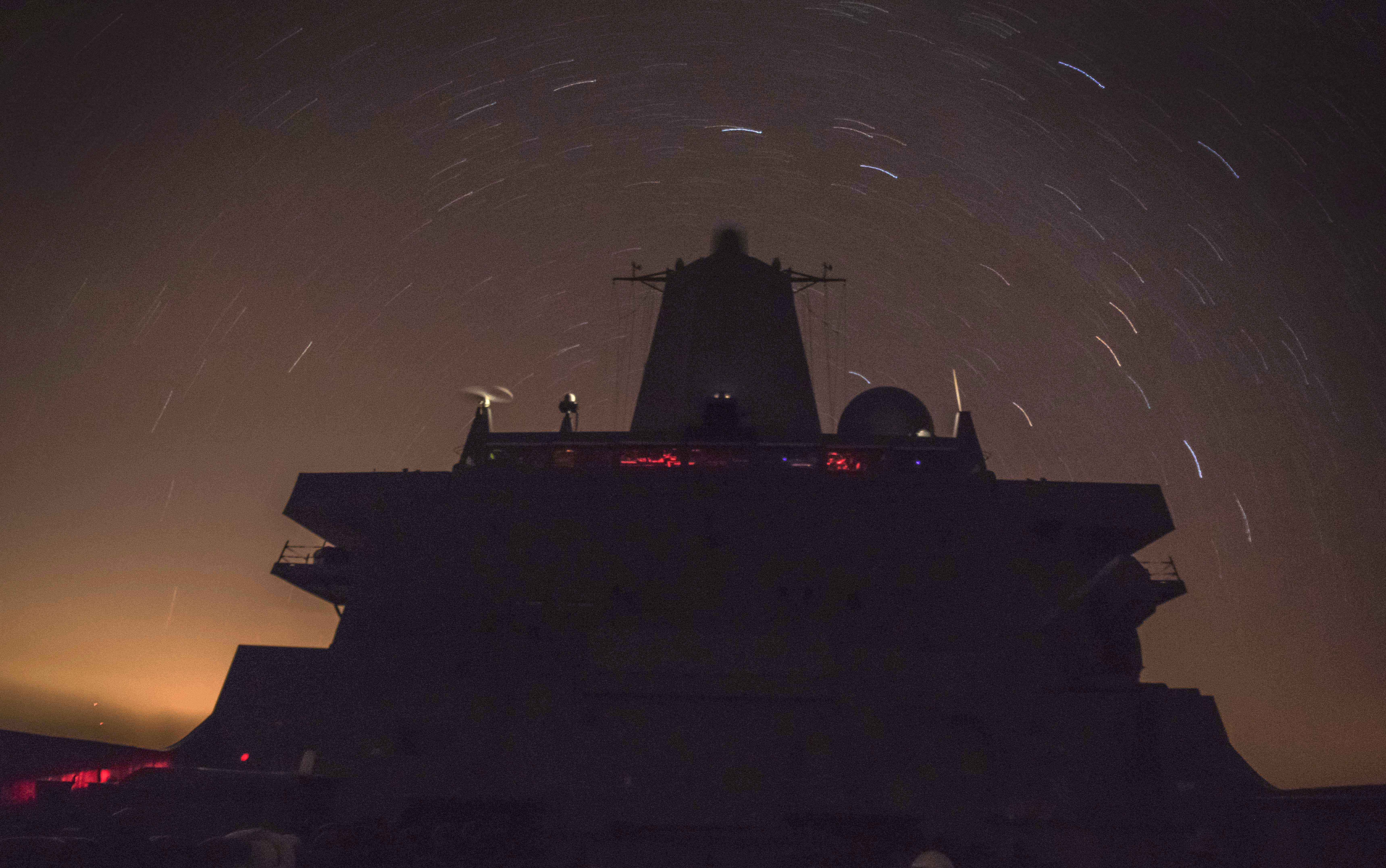 USS New Orleans (LPD-18) transits the Pacific Ocean at night. US Navy Photo