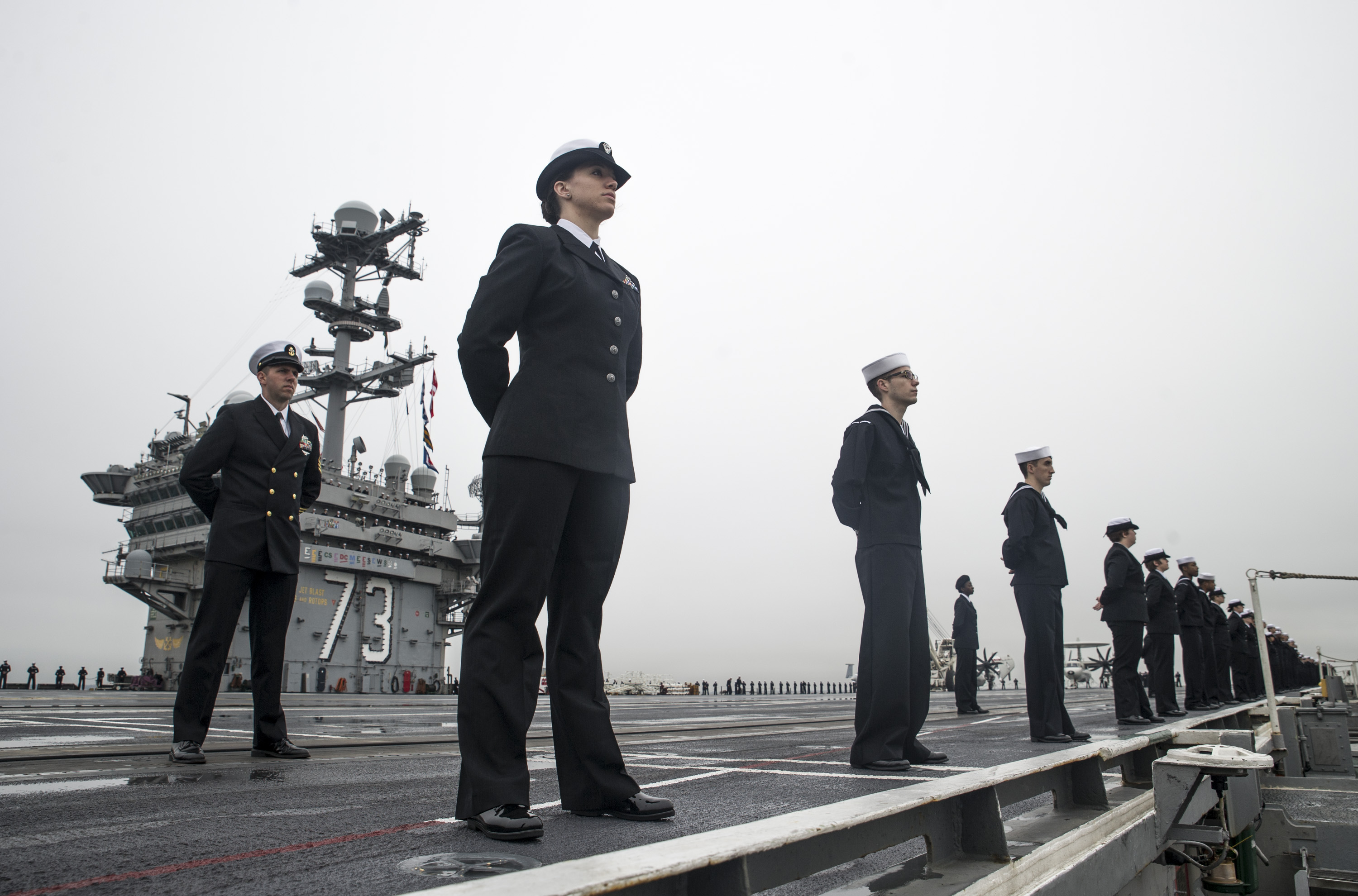  Sailors man the rails on the flight deck of aircraft carrier USS George Washington (CVN-73) as the ship arrives in its new homeport of Naval Station Norfolk, Va. in December, 2015. US Navy Photo