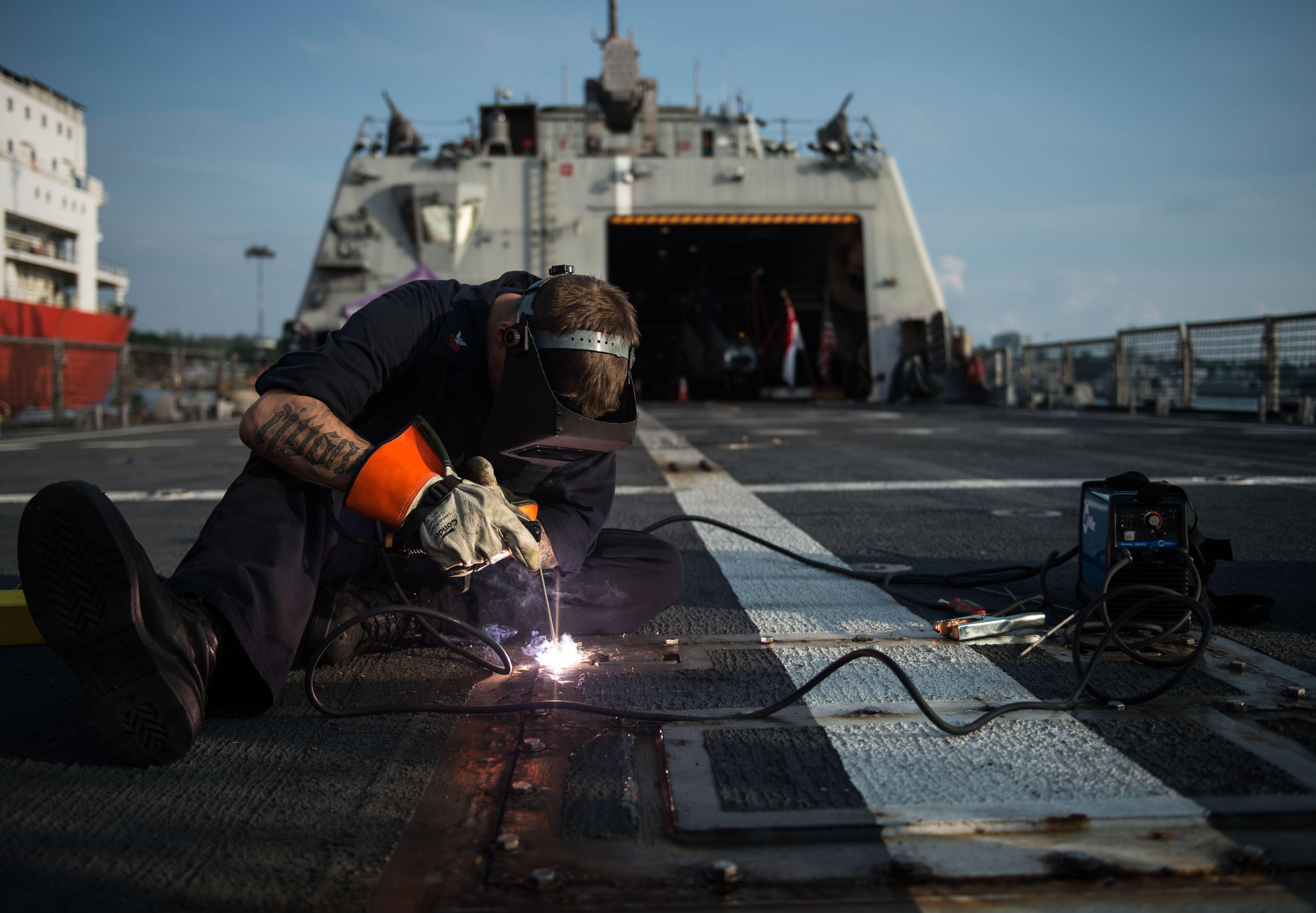 A sailor secures a bolt in place for the retractable bit for towing aboard USS Fort Worth (LCS-3). US Navy Photo