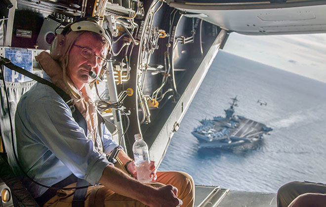 USS Theodore Roosevelt (CVN-71) in the background as Secretary of Defense Ash Carter flies in a V-22 Osprey on Nov. 5, 2015. DoD Photo