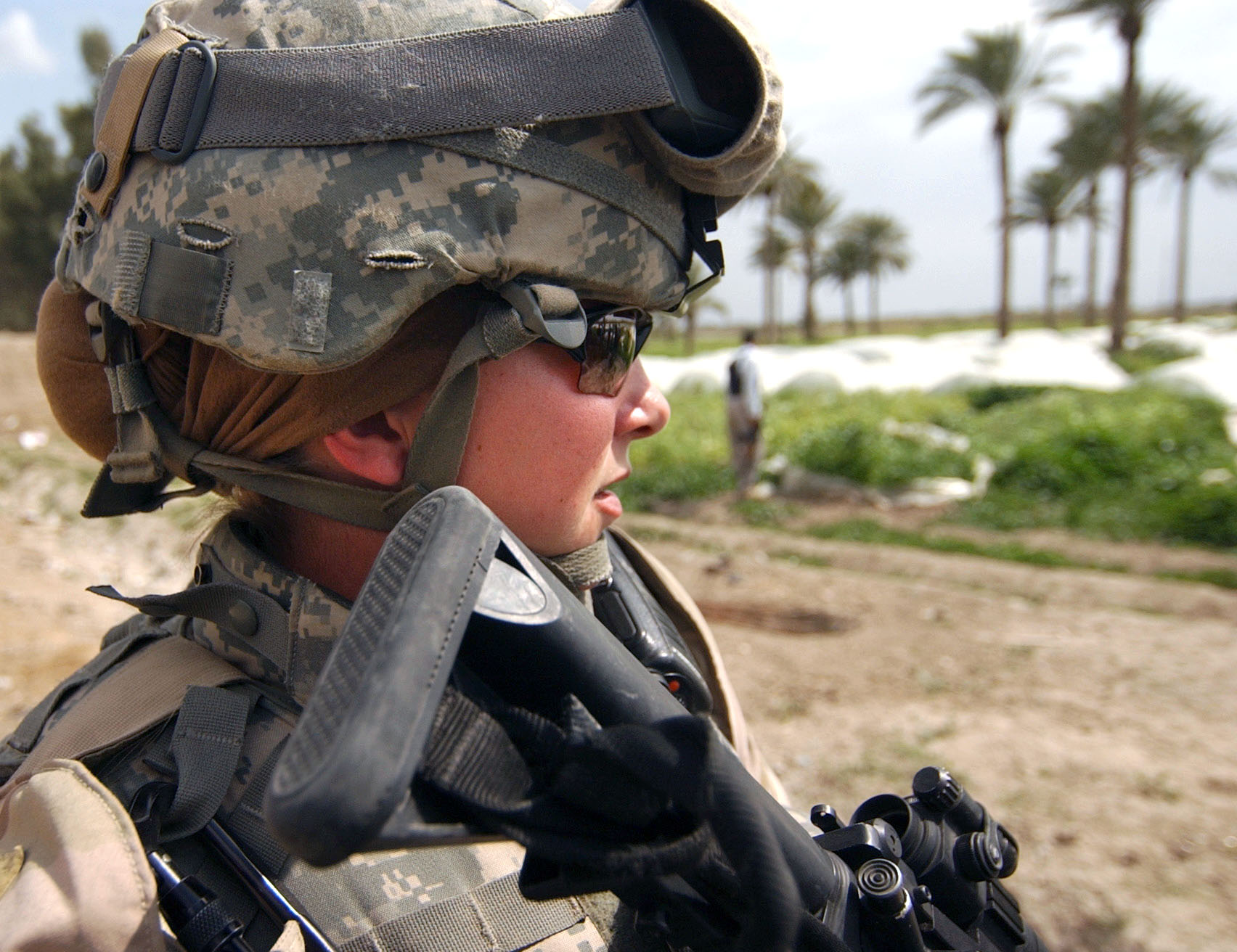 U.S. Army Sgt. Ashley Hort keeps her weapon at the ready as she provides security for her fellow soldiers during a raid in Al Haswah, Iraq, on March 21, 2007. US Army Photo