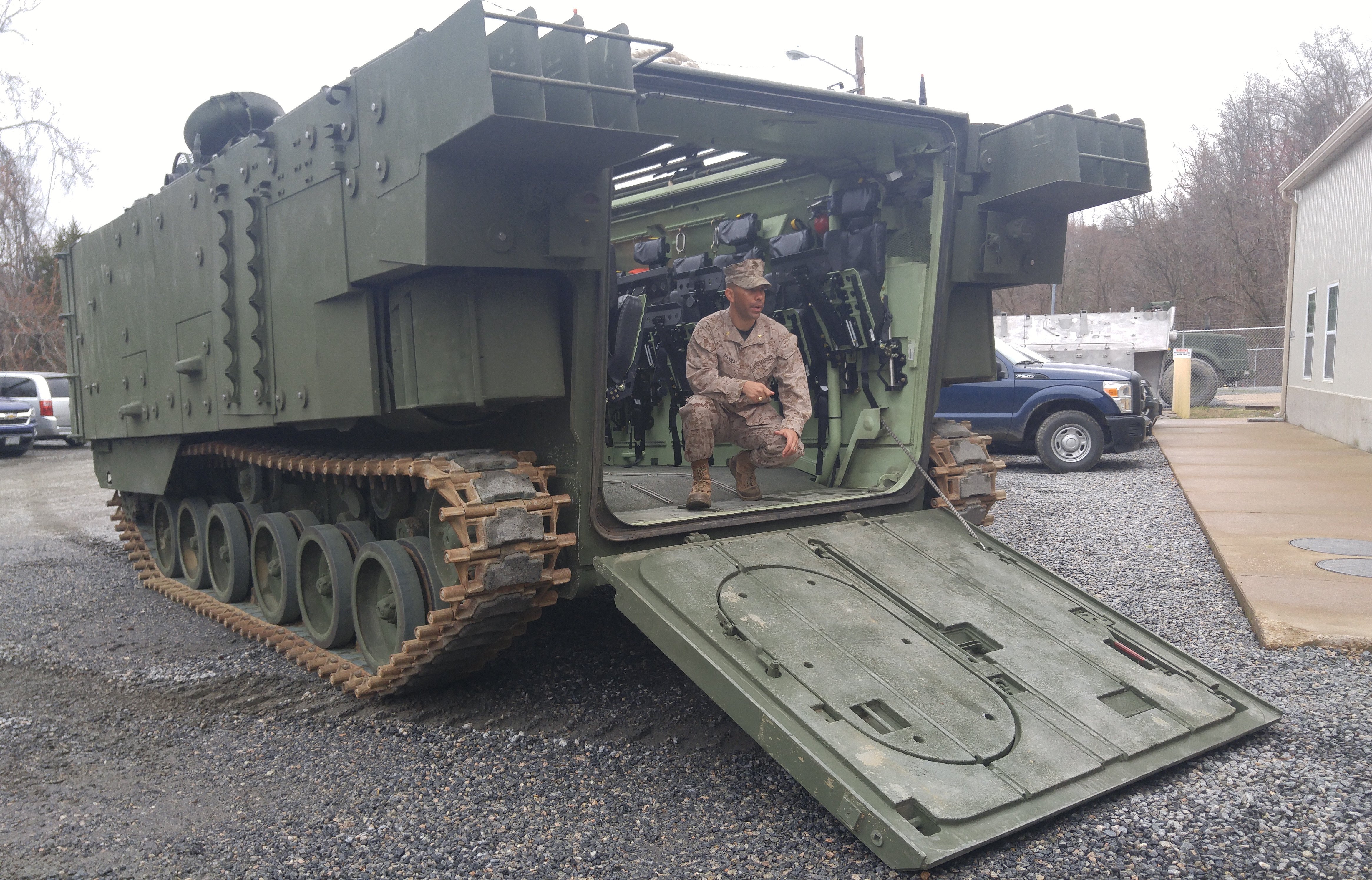 Amphibious Assault Vehicle Survivability Upgrade team lead Maj. Paul Rivera briefs media and program officials on the features of the first delivered vehicle near Marine Corps Base Quantico on March 15, 2016. USNI News photo.