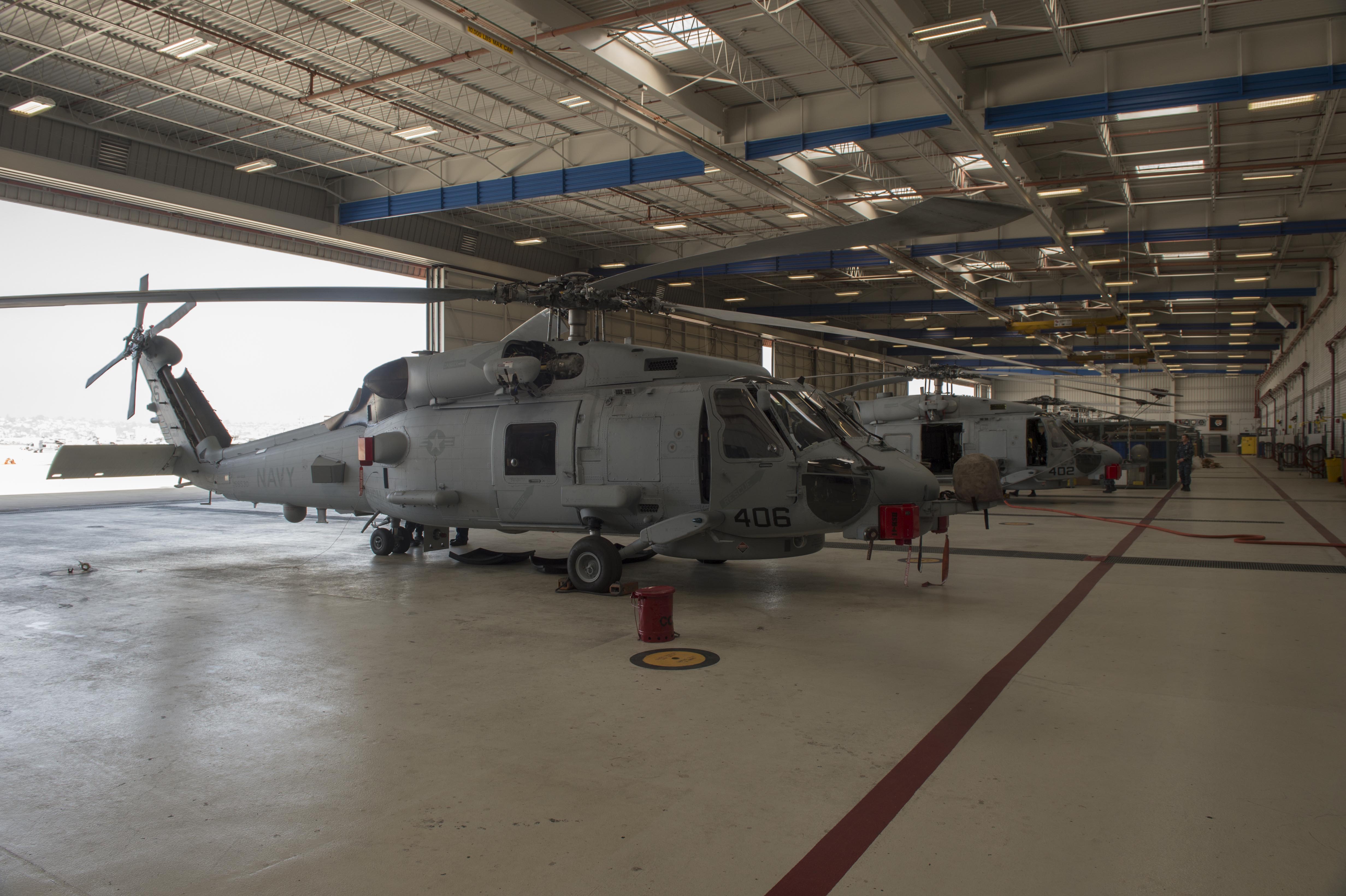 MH-60R Sea Hawk helicopters assigned to the Maritime Strike Squadron (HSM) 41 are parked on the flight line at Naval Air Station North Island. The Navy has spent its limited military construction funds on forward-located bases and training and maintenance facilities for new aircraft models, leaving little funding for maintaining and improving administrative and residential buildings. US Navy photo. 