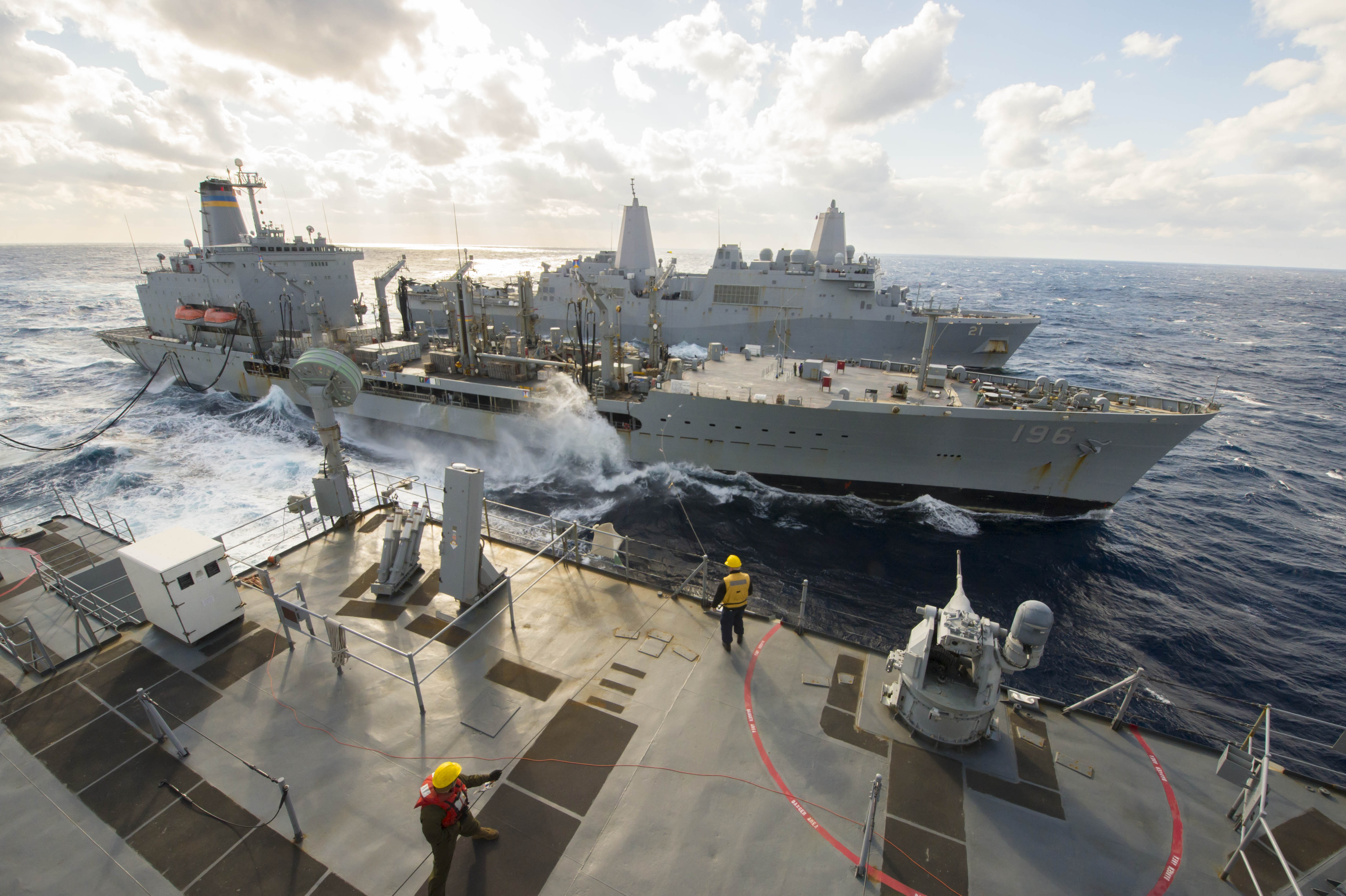 The Whidbey Island-class amphibious dock landing ship USS Fort McHenry (LSD 43), front, and the San Antonio-class amphibious transport dock USS New York (LPD 21), conduct an underway replenishment with the Military Sealift Command fleet replenishment oiler USNS Kanawha (T-AO-196) while operating in the Mediterranean Sea in January 2015. US Navy photo.