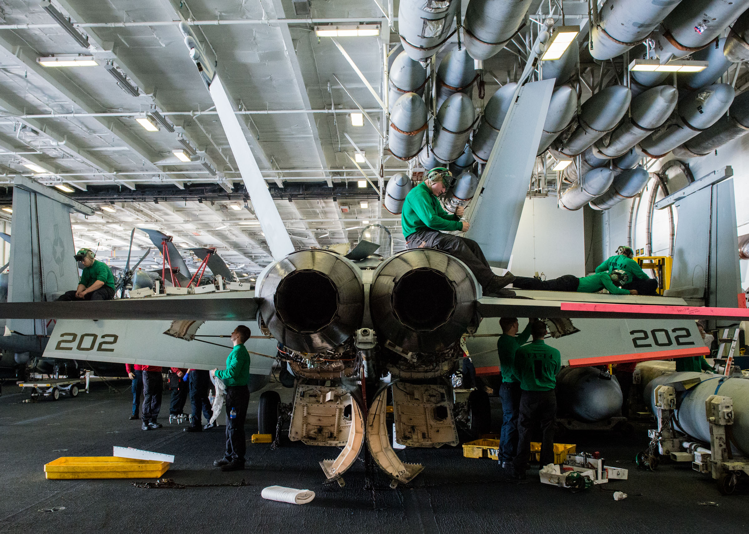 Sailors perform maintenance on an F/A-18E Super Hornet from the Top Hatters of Strike Fighter Squadron (VFA) 14 USS John C. Stennis' (CVN 74) hangar bay on Jan. 22, 2016. US Navy photo.
