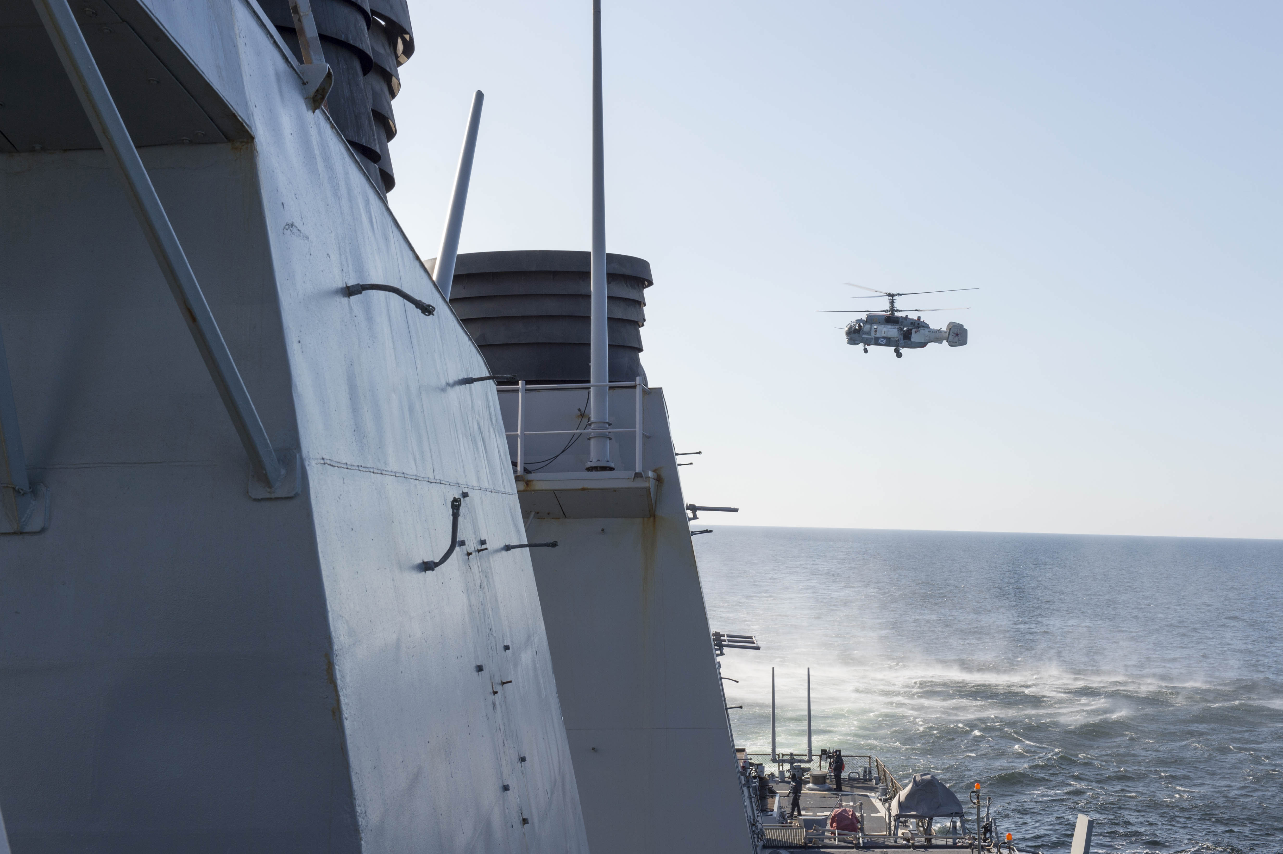 A Russian Kamov KA-27 HELIX flies low-level passes near the Arleigh Burke-class guided missile destroyer USS Donald Cook (DDG-75) on April 12, 2016. US Navy Photo