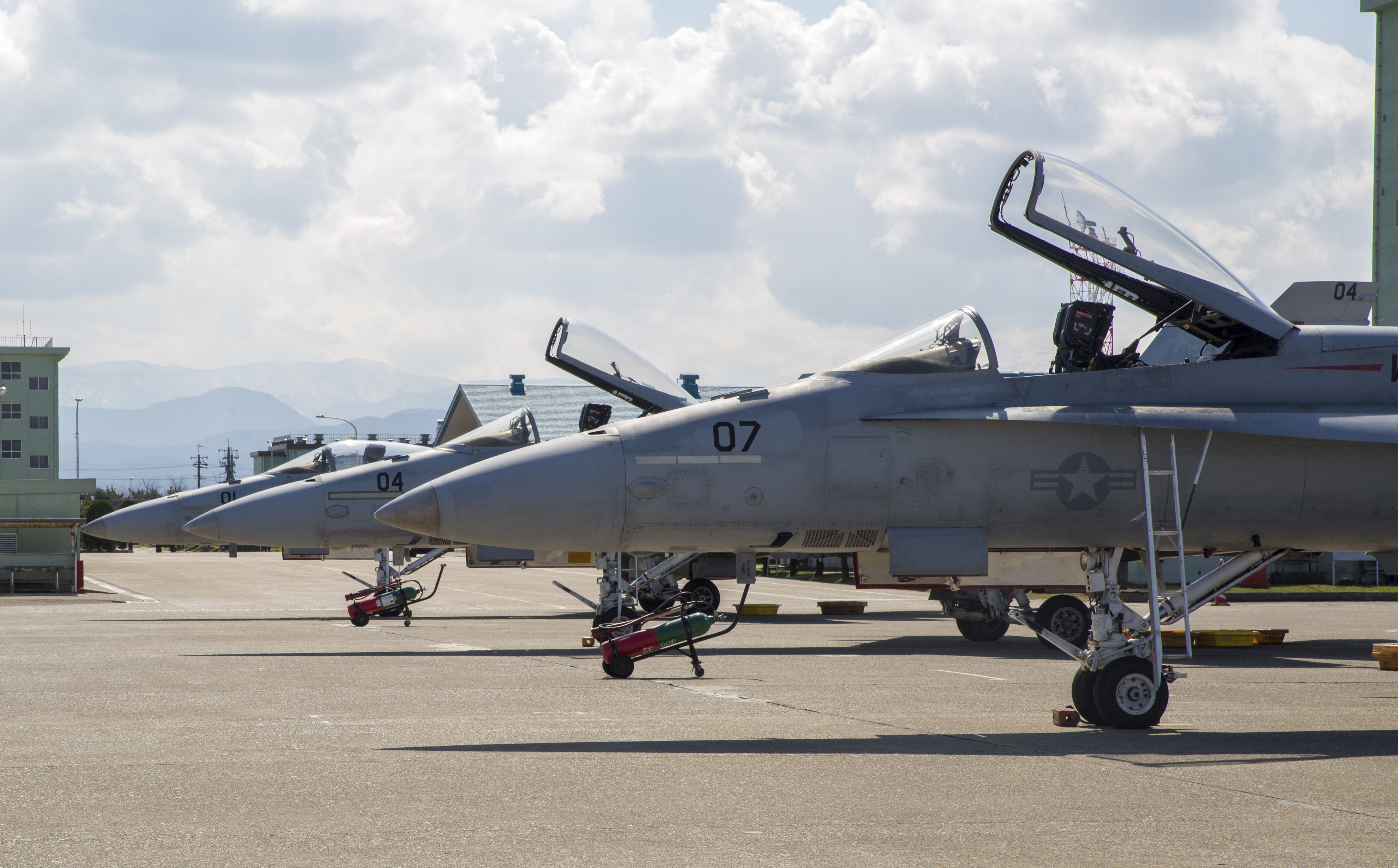FA-18A++ Hornets with Marine Fighter Attack Squadron(VMFA) 314, forward based at Marine Corps Air Station Iwakuni, Japan, are lined up on the flightline at Komatsu Air Base, Japan, during the Komatsu Aviation Training Relocation exercise March 7-18, 2016. US Marine Corps photo.
