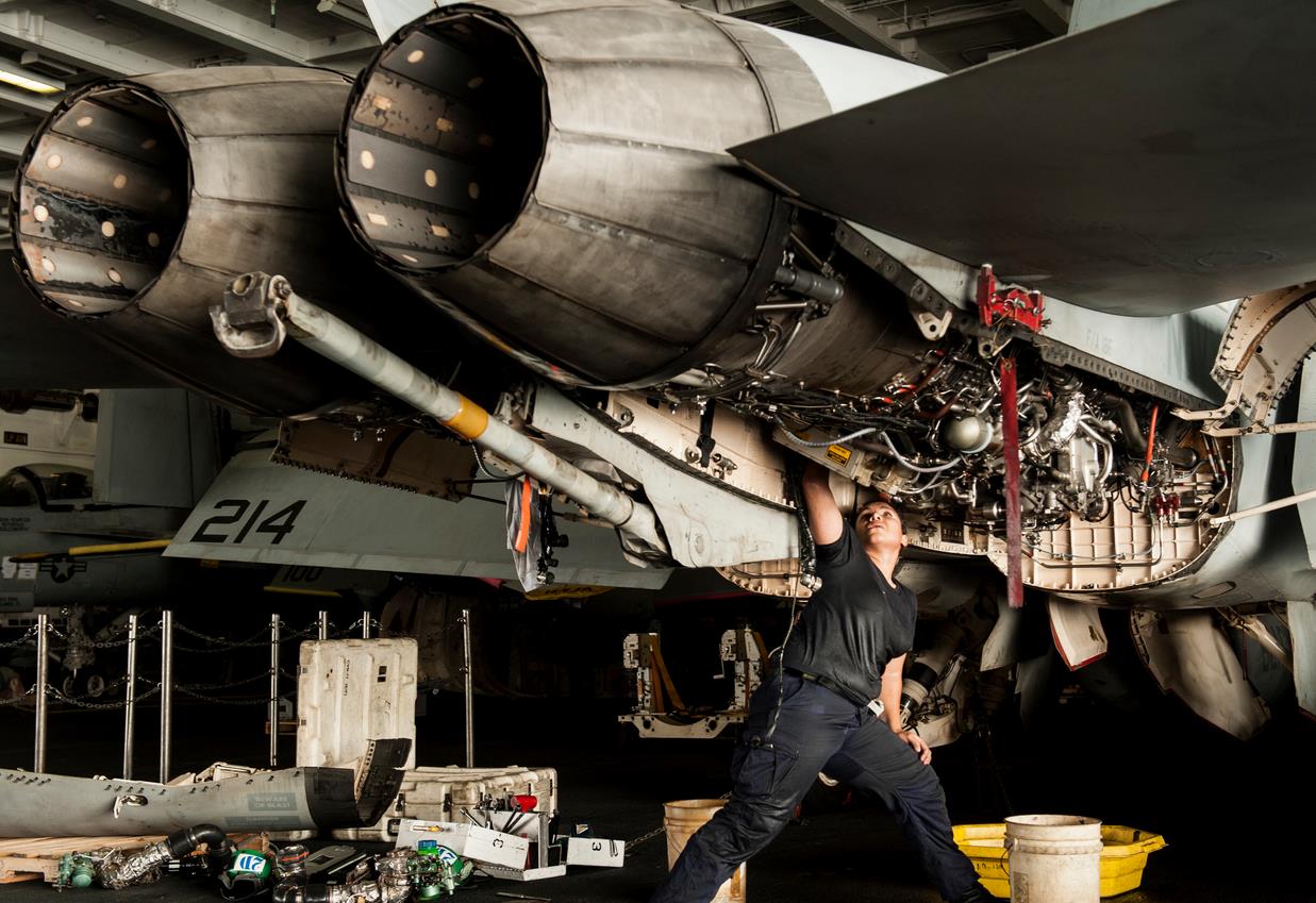 Aviation Machinist’s Mate 2nd Class Alexandra Mimbela performs maintenance on an F/A-18F Super Hornet. US Navy Photo