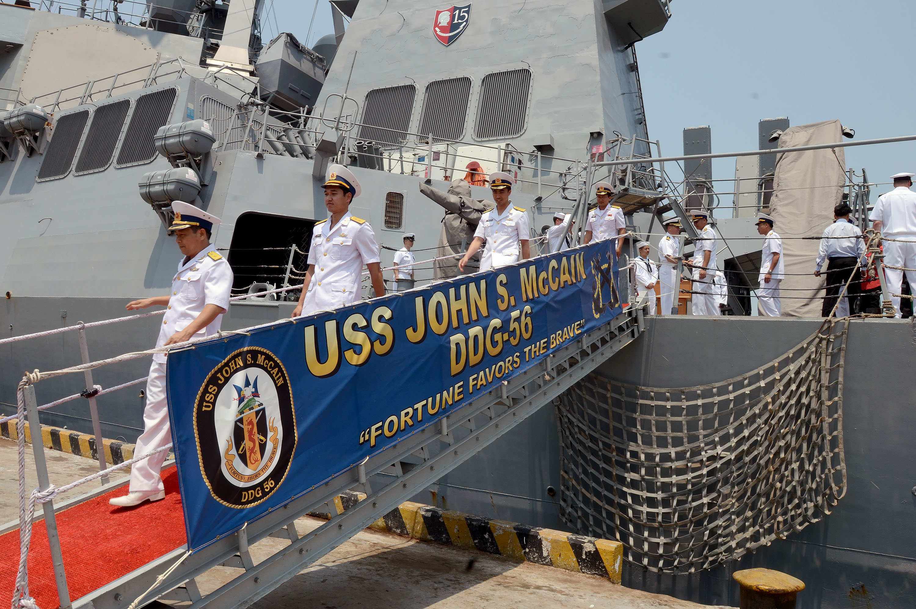 140407-N-YU572-329 DA NANG, Vietnam (April 7, 2014) Members of the Vietnam People’s Navy depart the Arleigh Burke-class guided-missile destroyer USS John S. McCain (DDG 56) following a shipboard tour in support of Naval Engagement Activity (NEA) Vietnam. The NEA provides opportunities for U.S and Vietnamese naval professionals to share best practices and maritime skills in non-combatant areas, such as military medicine, search and rescue, diving and salvage and shipboard damage control. Approximately 400 U.S. Navy Sailors and civilian mariners are participating in NEA Vietnam 2014. (U.S Navy photo by Mass Communication Specialist 1st Class Jay C. Pugh/Released)