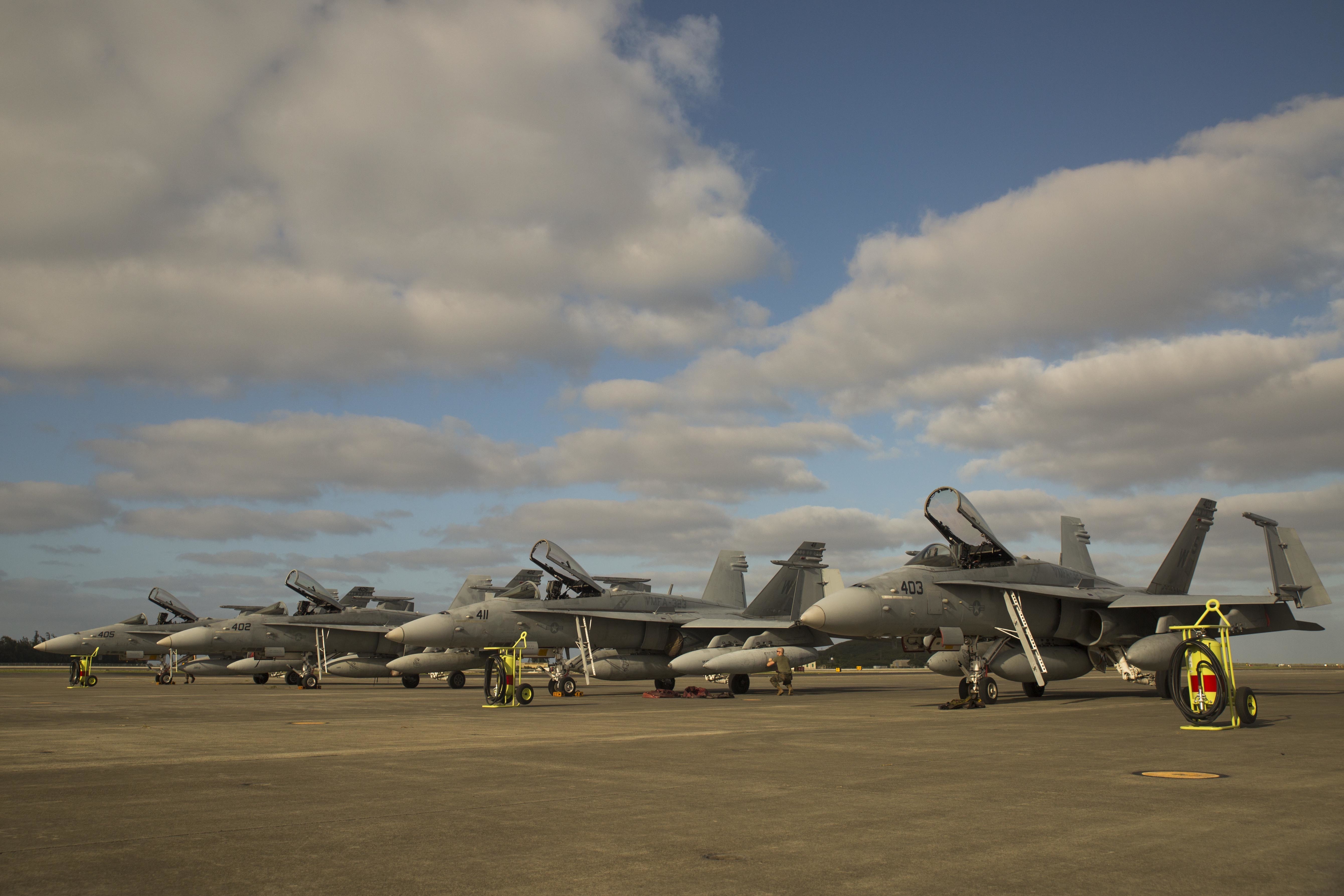 A Marine inspects an F/A-18C Hornet from Marine Fighter Attack Squadron 323, Jan. 7, 2015. US Marine Corps photo.
