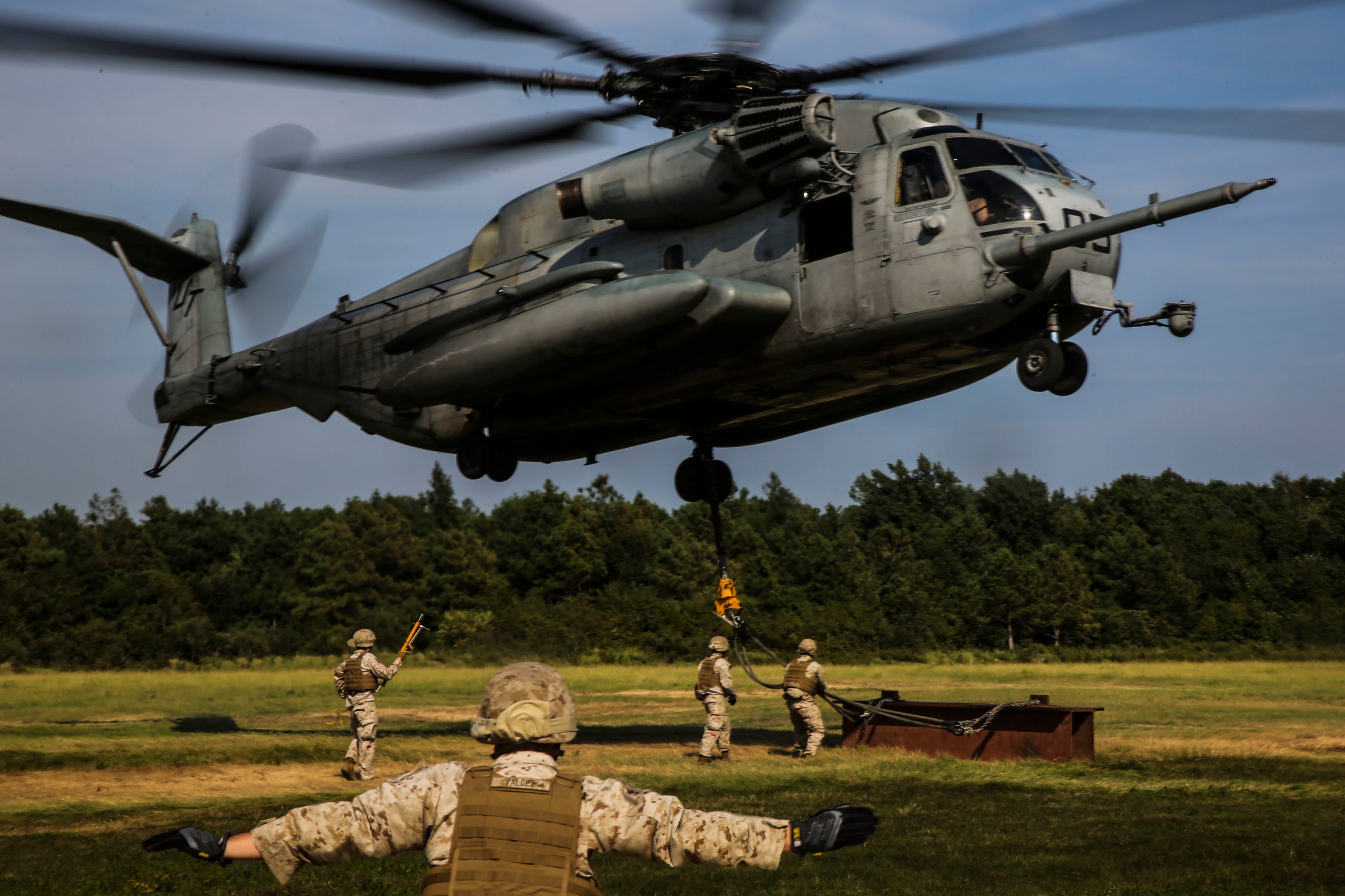 A Marine guides a CH-53 Super Stallion during a helicopter support team exercise at Landing Zone Albatross aboard Camp Lejeune, N.C., Sept. 2, 2015. US Marine Corps photo.