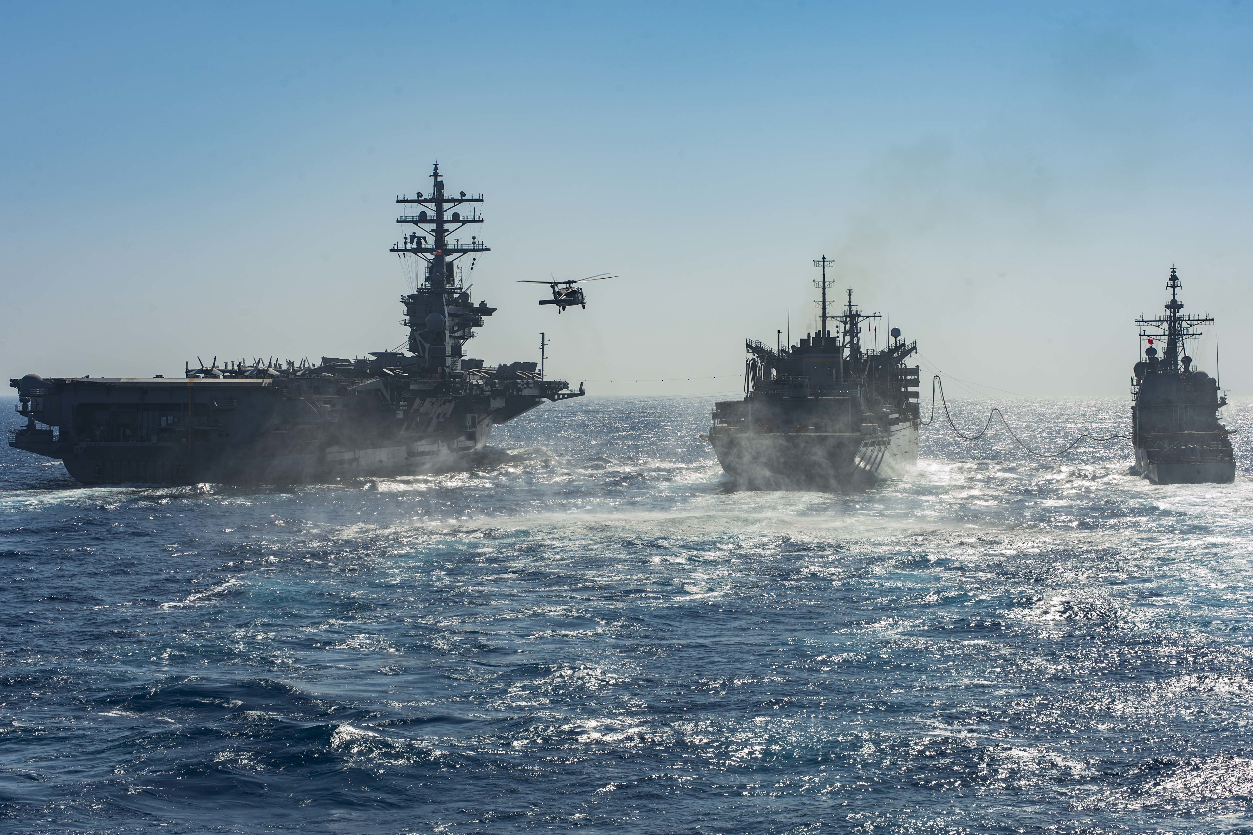 160614-N-EO381-054 MEDITERRANEAN SEA (June 14, 2016) An MH-60R Seah Hawk helicopter assigned to the Dusty Dogs of Helicopter Sea Combat Squadron (HSC) 7 flies from the aircraft carrier USS Dwight D. Eisenhower (CVN 69), left, and the guided-missile cruiser USS San Jacinto (CG 56) during a replenishment-at-sea with the fast combat support ship USNS Arctic (T-AOE 8). The Eisenhower Carrier Strike Group is conducting naval operations in the U.S. 6th Fleet area of operations in support of U.S. national security interests in Europe. (U.S. Navy photo by Mass Communication Specialist 3rd Class Casey J. Hopkins/Released)