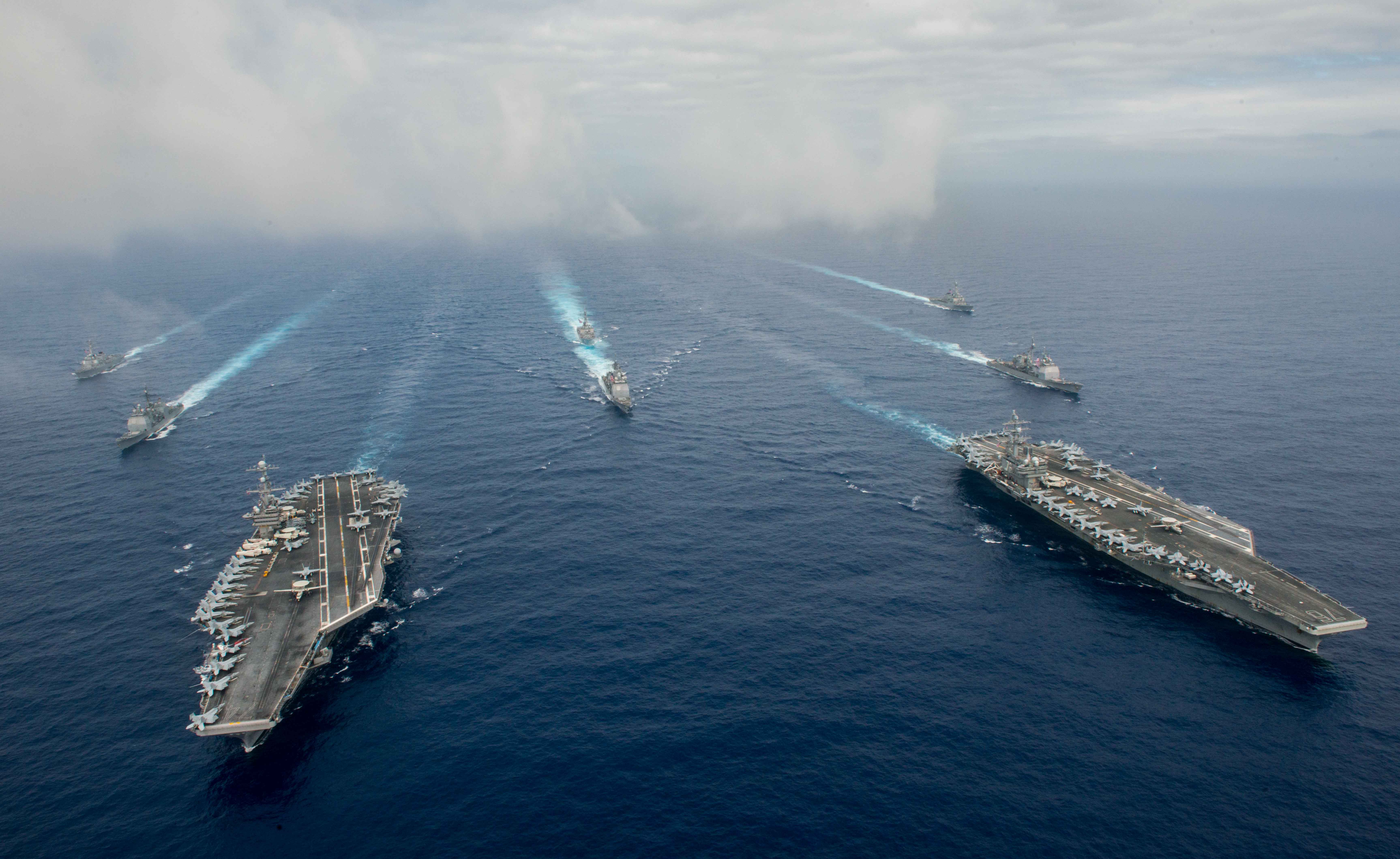 The Nimitz-class aircraft carriers USS John C. Stennis (CVN 74), left, and USS Ronald Reagan (CVN 76) conduct dual aircraft carrier strike group operations in the U.S. 7th Fleet area of operations in support of security and stability in the Indo-Asia-Pacific. US Navy photo.