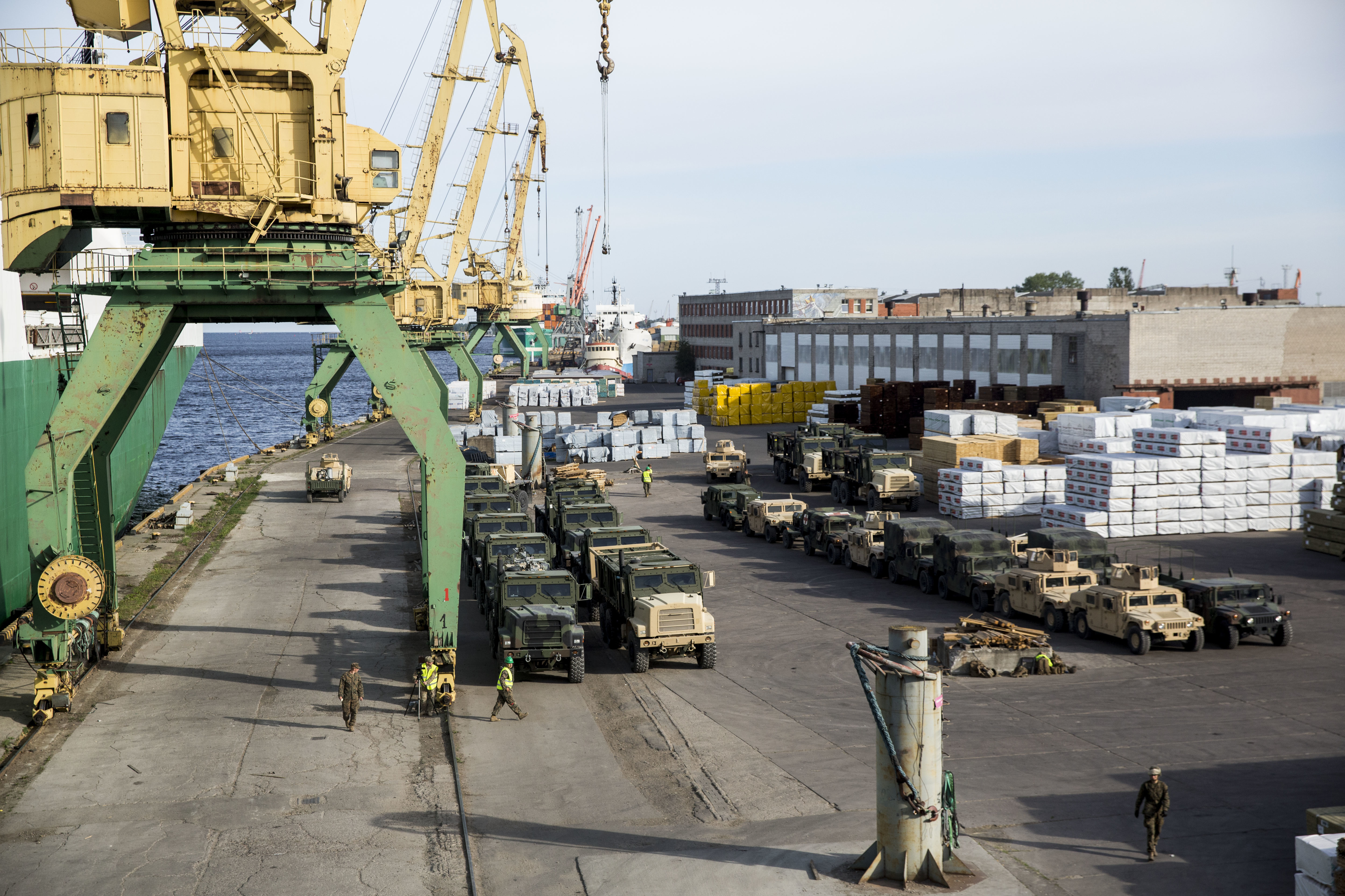 A fleet of military vehicles wait pier side in preparation of Exercise Saber Strike 16 in Riga, Latvia, June 4, 2016. The vehicles were transported by a British Roll-On, Roll-Off ship from Norway for the exercise. US Marine Corps photo.