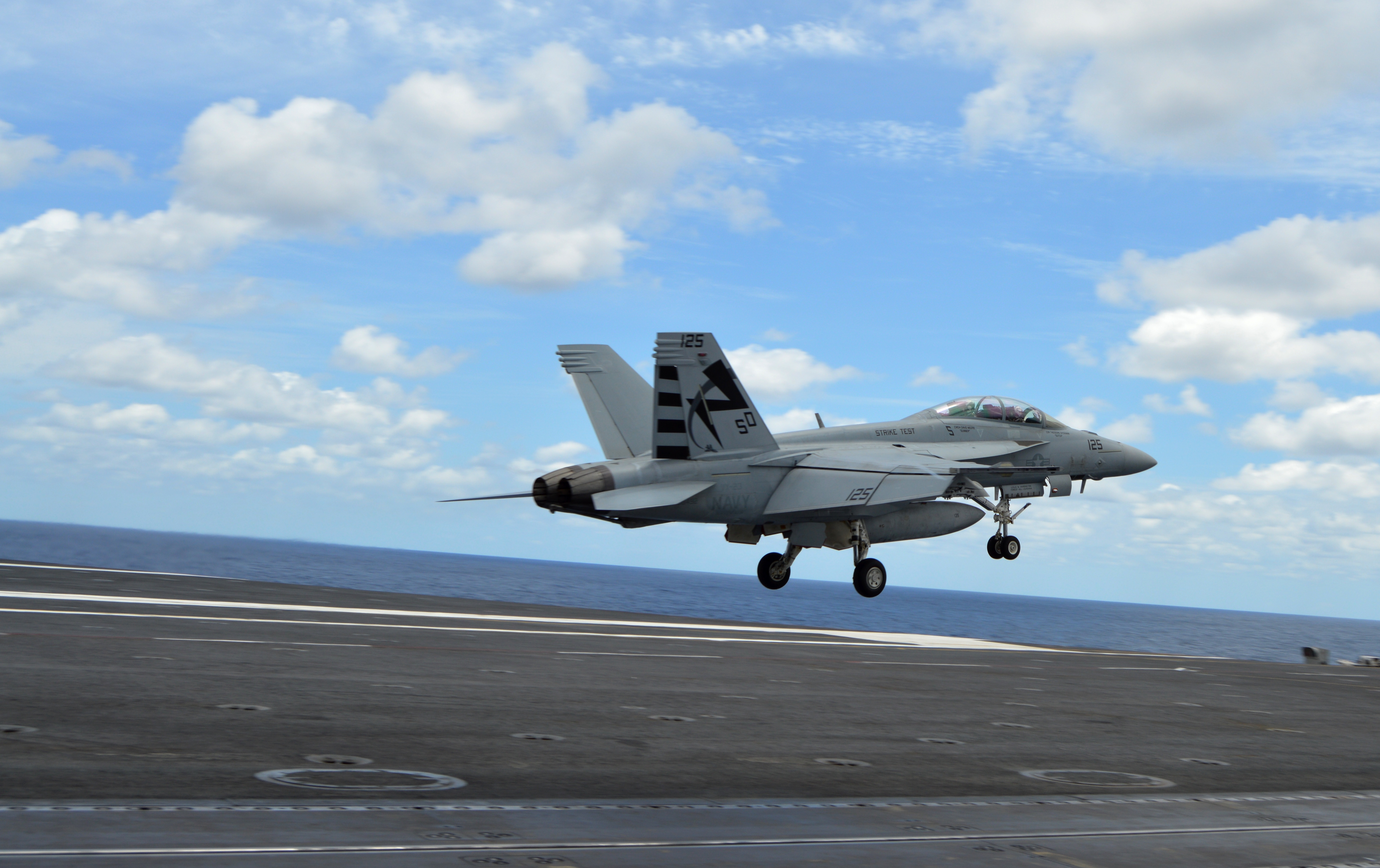 An F/A-18F Super Hornet in Air Test and Evaluation Squadron (VX) 23 conducts touch-and-go flight operations off the deck of USS George Washington (CVN-73) on June 27, 2016, while testing the MAGIC CARPET carrier landing assistance technology. USNI News photo.