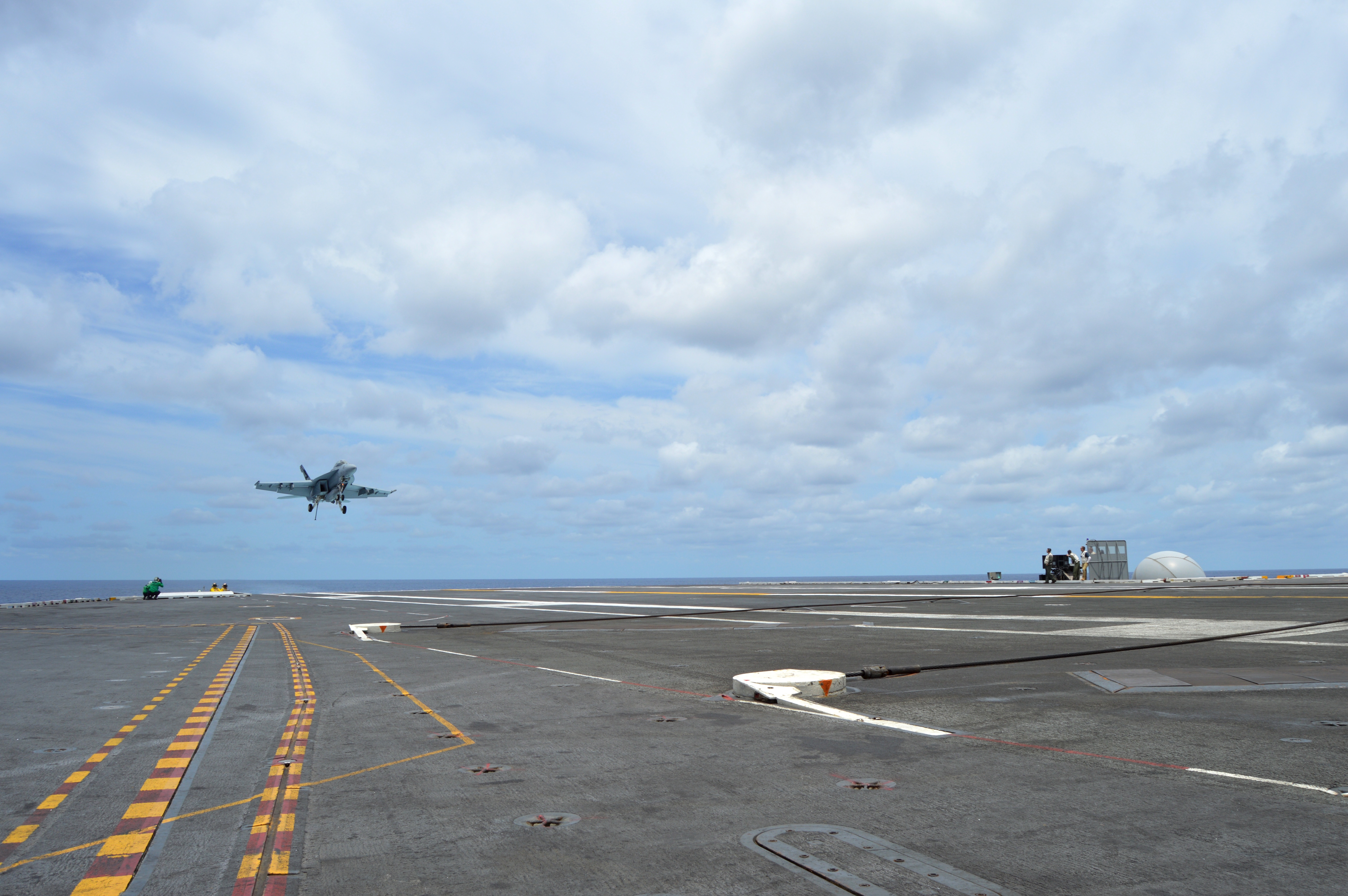 An F/A-18F Super Hornet in Air Test and Evaluation Squadron (VX) 23 comes in for an arrested landing on the deck of USS George Washington (CVN-73) on June 27, 2016, while testing the MAGIC CARPET carrier landing assistance technology. USNI News photo.