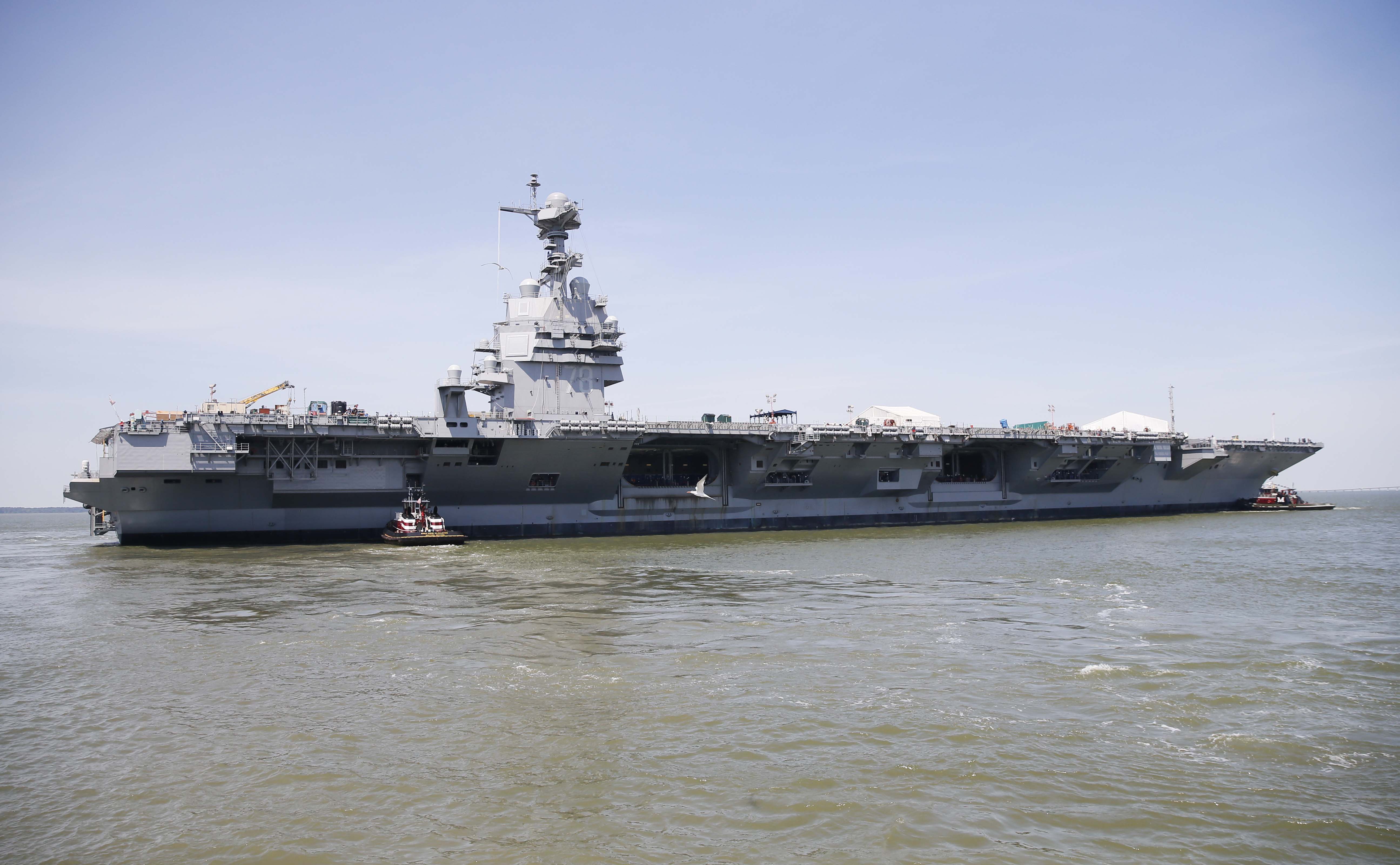 Tug boats maneuver Pre-Commissioning Unit Gerald R. Ford (CVN 78) into the James River during the ship's Turn Ship evolution on June 11, 2016. US Navy photo.