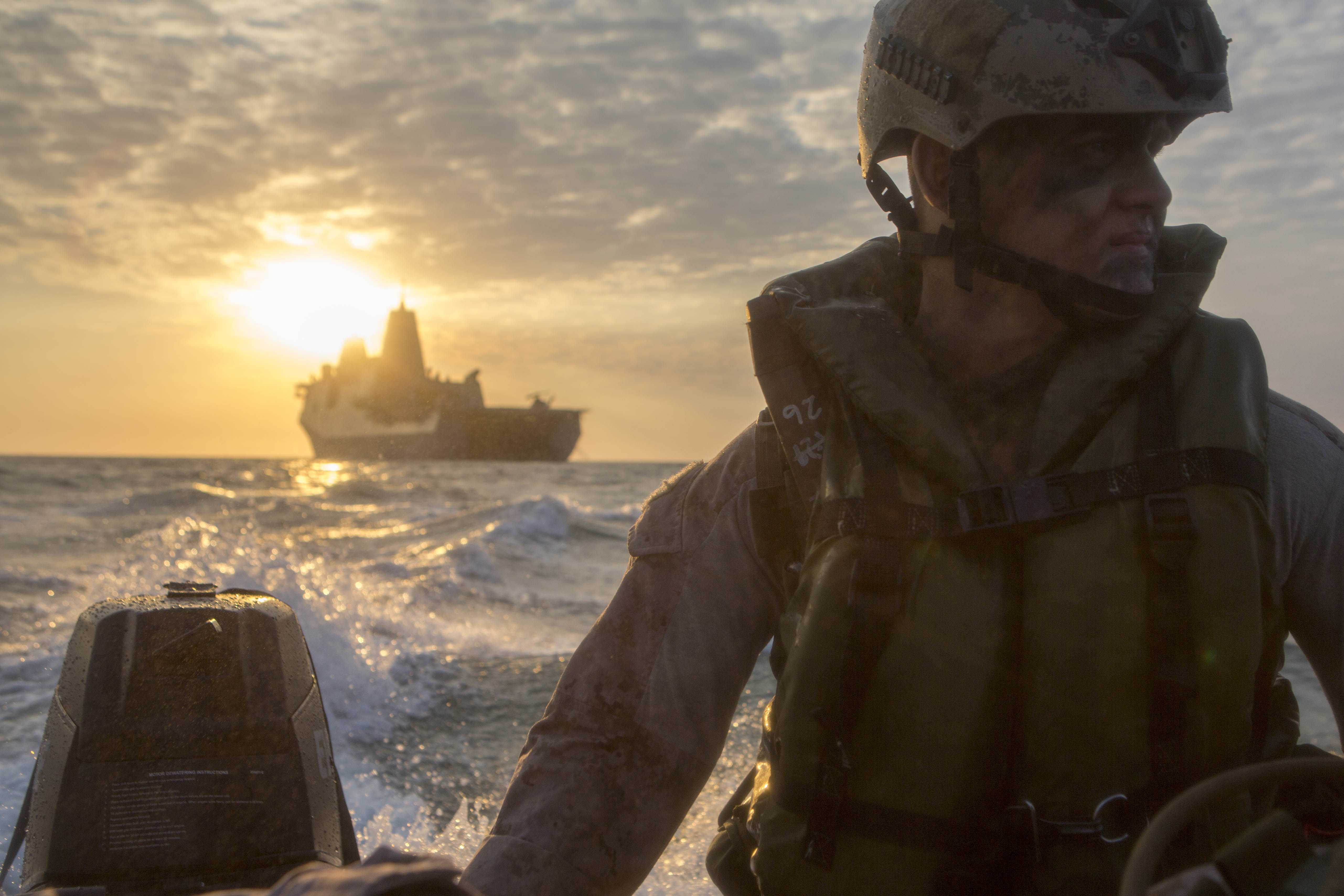 U.S. Marine Corps Lance Cpl. Chance Seckenger rides in a Combat Rubber Raiding Craft from the well deck of the USS Green Bay (LPD-20), at sea, July 9, 2015. US Marine Corps Photo