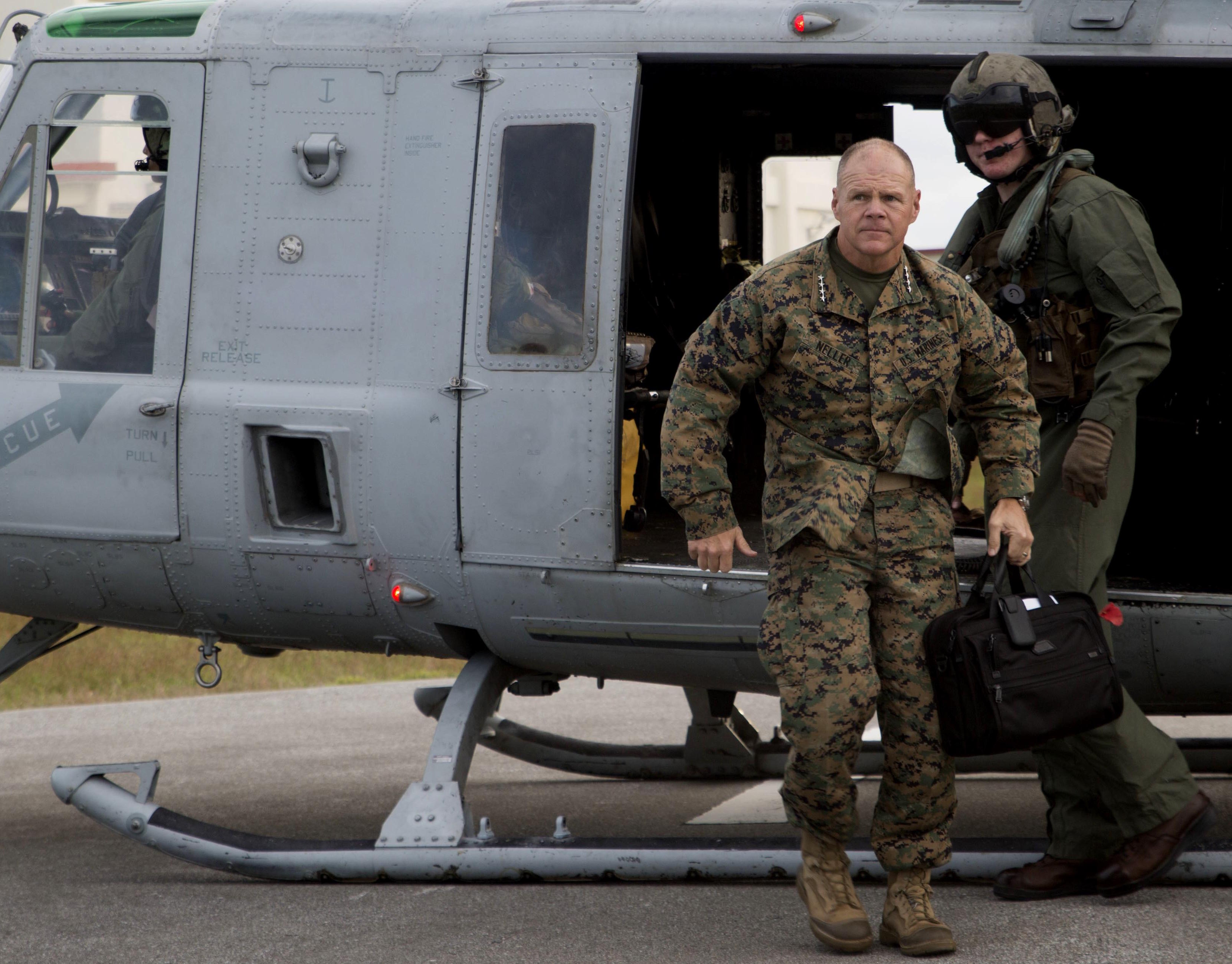 Gen. Robert B. Neller steps out of a UH-1 Huey to talk with Marines Nov. 23 2015 at the Camp Hansen Theater, Camp Hansen, Okinawa. US Marine Corps Photo