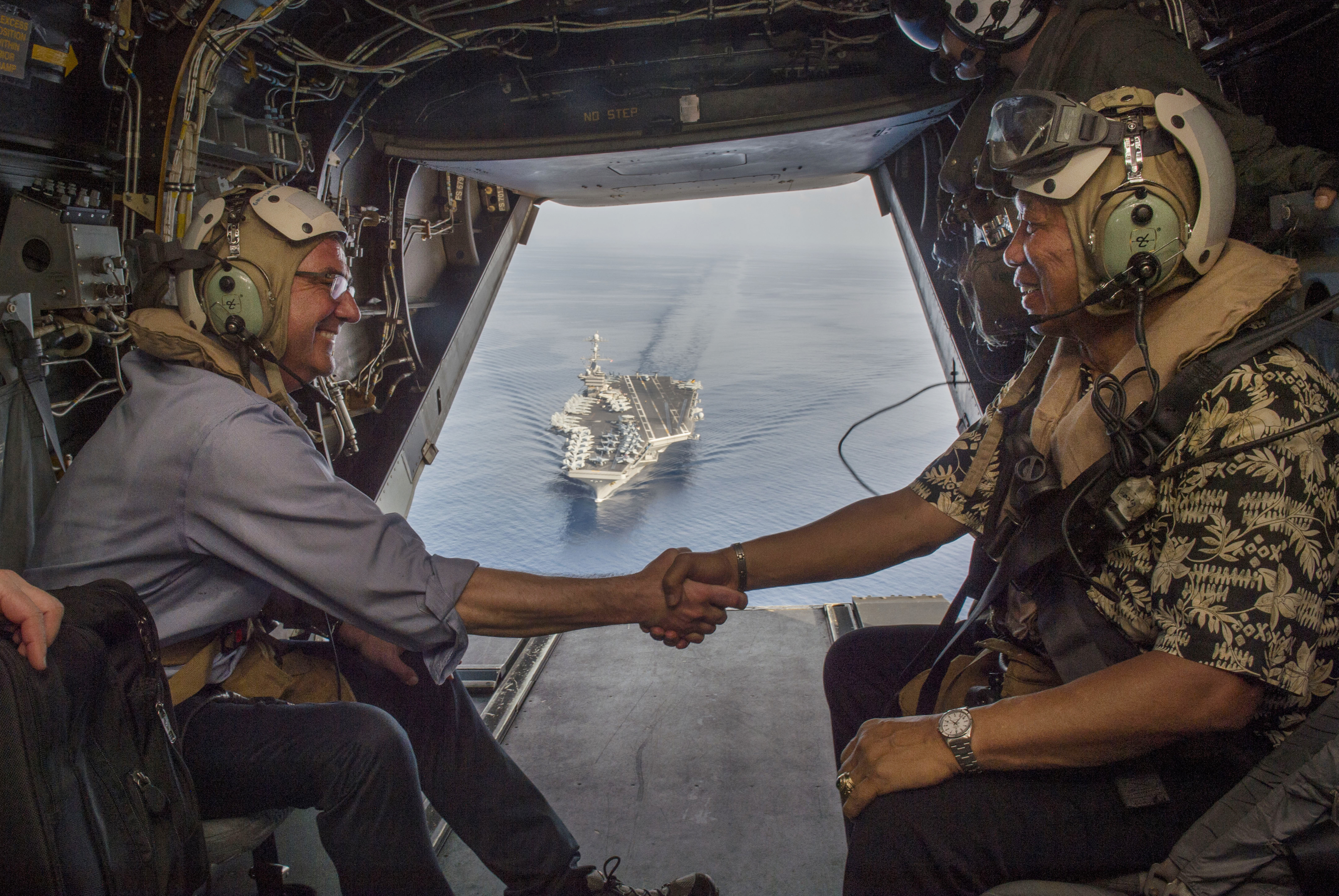 Secretary of Defense Ash Carter (left) and Philippine Secretary of National Defense Voltaire Gazmin (right) shake hands on a Marine Corps V-22 Osprey as they depart the USS Stennis after touring the aircraft carrier as it sails the South China Sea April 15, 2016. Defense Department photo.