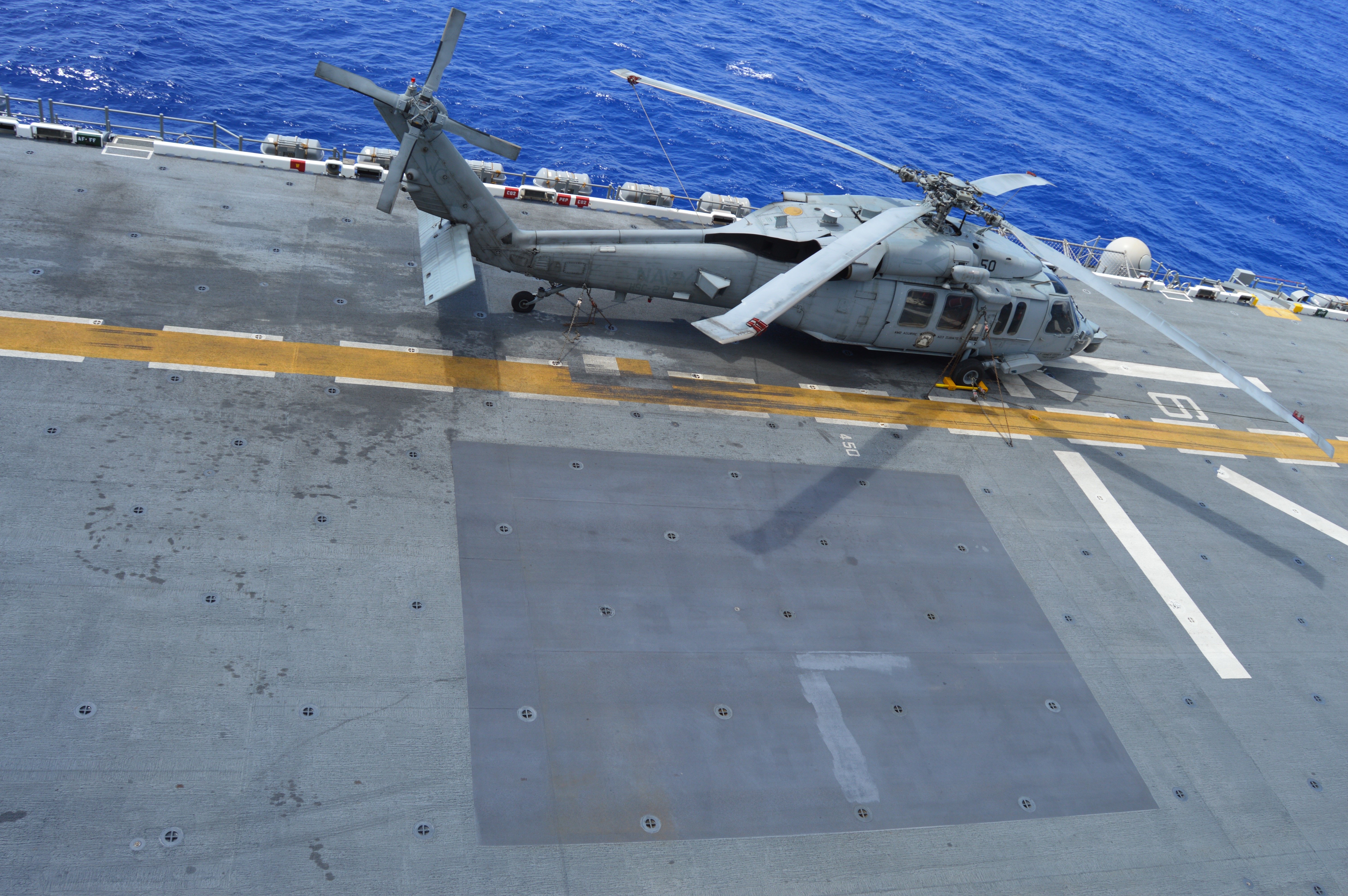 When the flight deck of USS America was redone to support F-35B operations, patches of advanced non-skid material were added to allow the MV-22 Osprey to land in more spots on the deck without causing damage with its extreme heat and wind while landing vertically. USNI News photo.