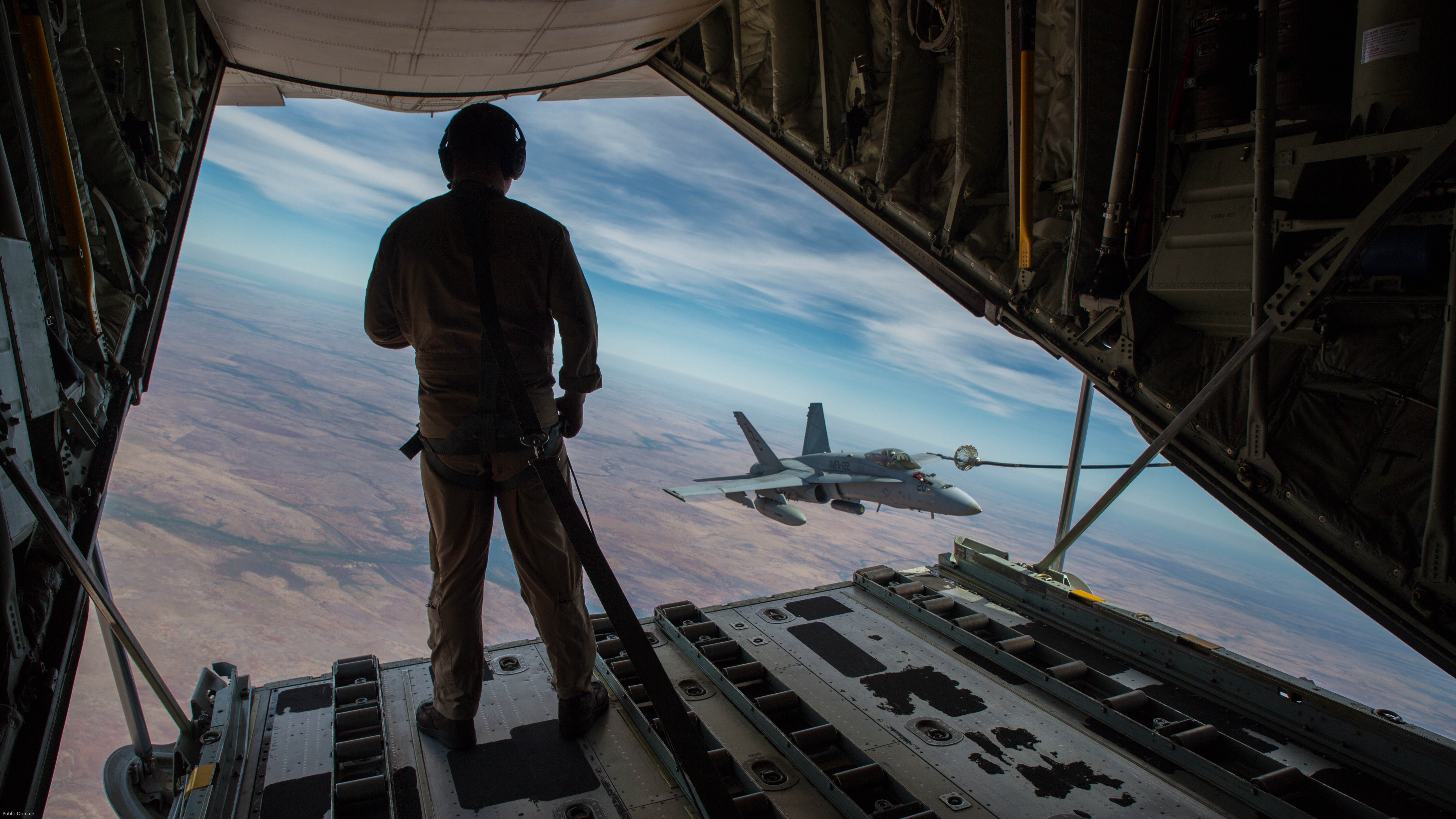 U.S. Marine Corps Cpl. Chris Lawler, a crewmaster with Marine Aerial Refueler Transport Squadron (VMGR) 152, observes an F/A-18C Hornet with Marine Fighter Attack Squadron (VMFA) 122 approach the refueling hose during Exercise Pitch Black 2016 at Royal Australian Air Force Base Tindal, Australia, Aug. 9, 2016. U.S. Marine Corps Photo