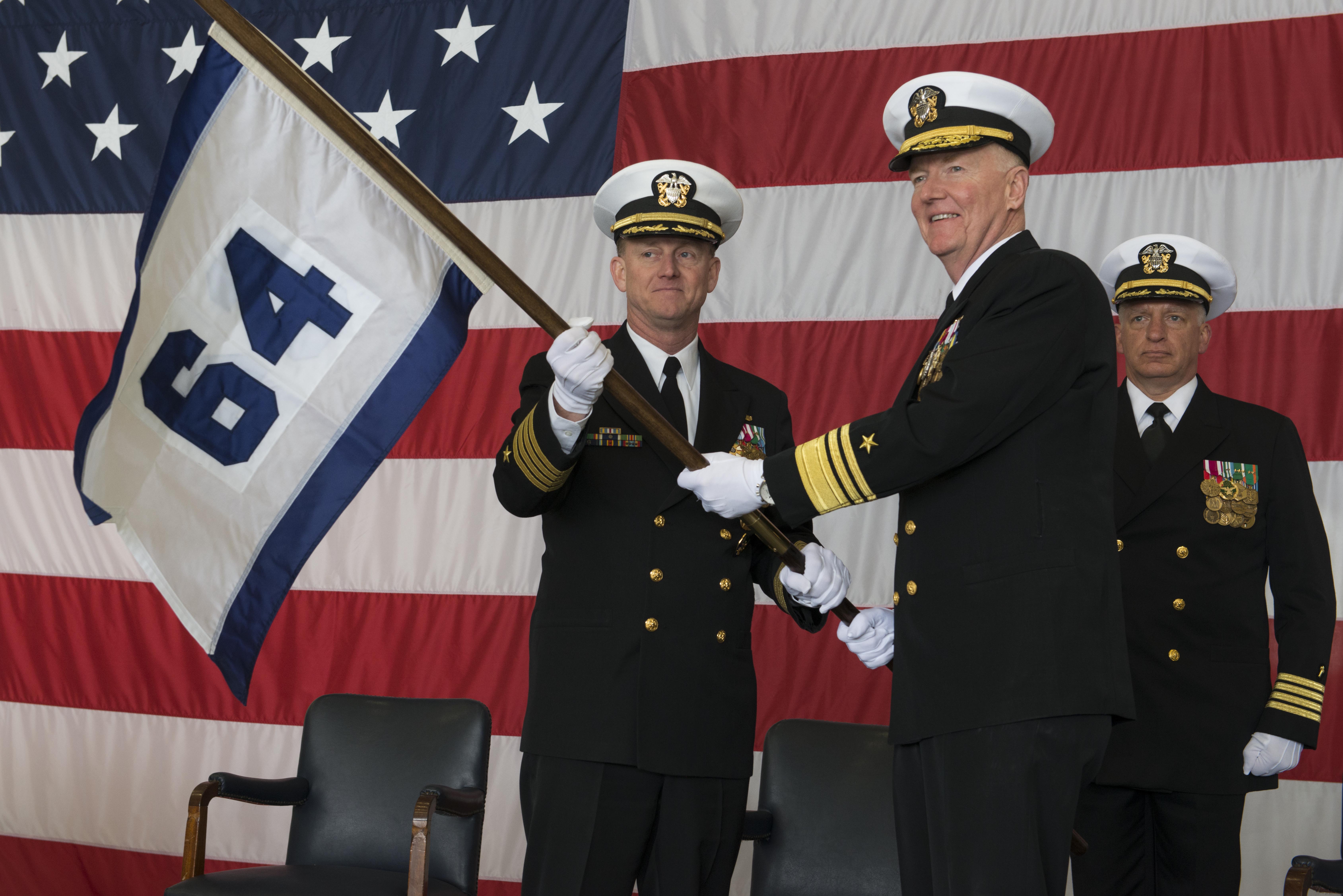 Vice Adm. James Foggo III, right, commander of U.S. 6th Fleet, hands Capt. Jeffrey Wolstenholme the Commander, Task Force 64 (CTF 64) guidon during the command’s establishment ceremony at U.S. Naval Support Activity Naples March 24, 2016. US Navy photo.