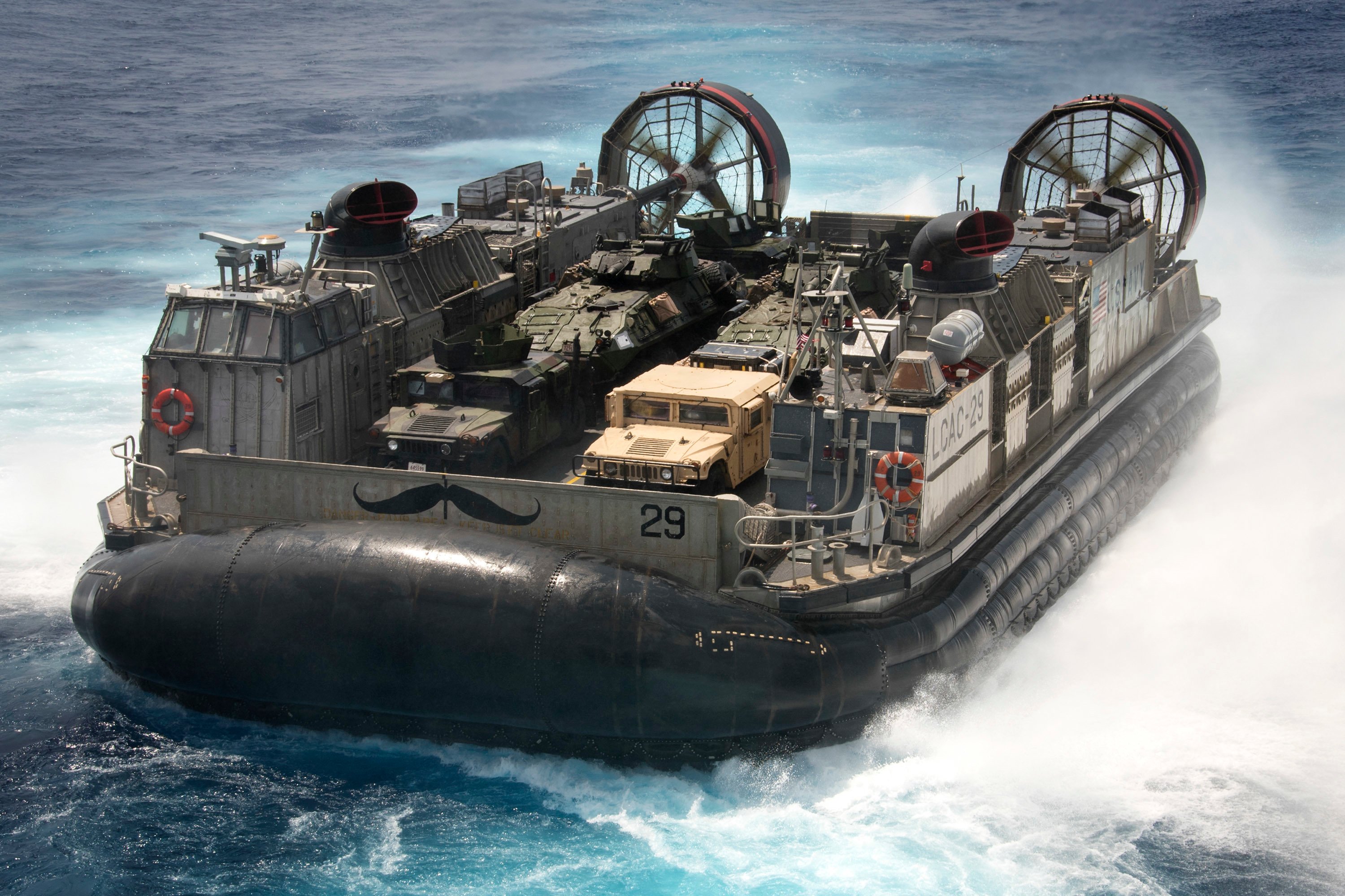 Landing craft air cushion (LCAC) 29, assigned to Naval Beach Unit (NBU) 7, disembarks from amphibious assault ship USS Bonhomme Richard (LHD 6) in the Philippine Sea on Sept. 11, 2016. US Navy photo.