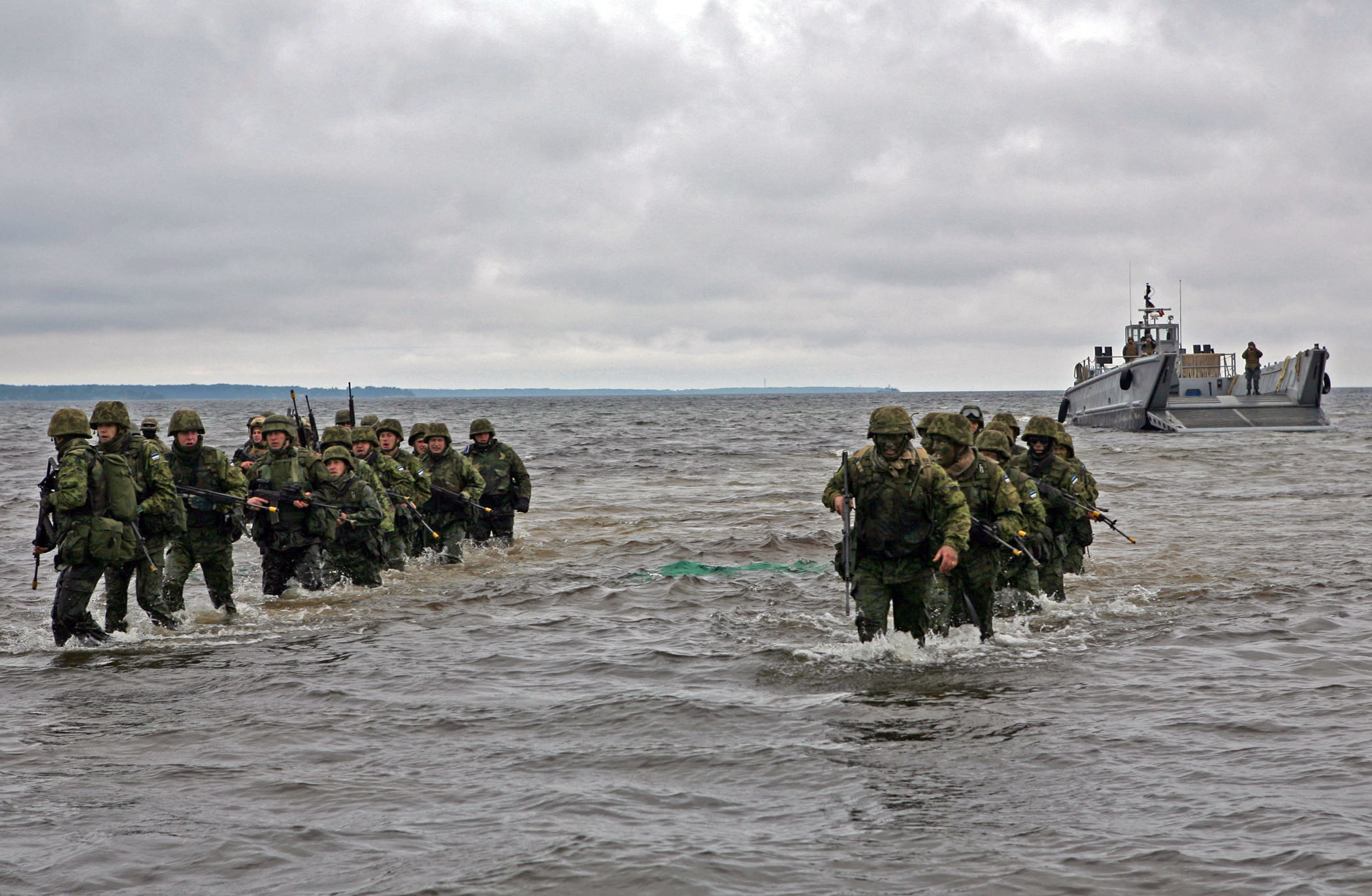 Estonian soldiers wade ashore during a combined U.S. and Estonia amphibious assault training exercise during Baltic Operations (BALTOPS) 2010. US Navy Photo 