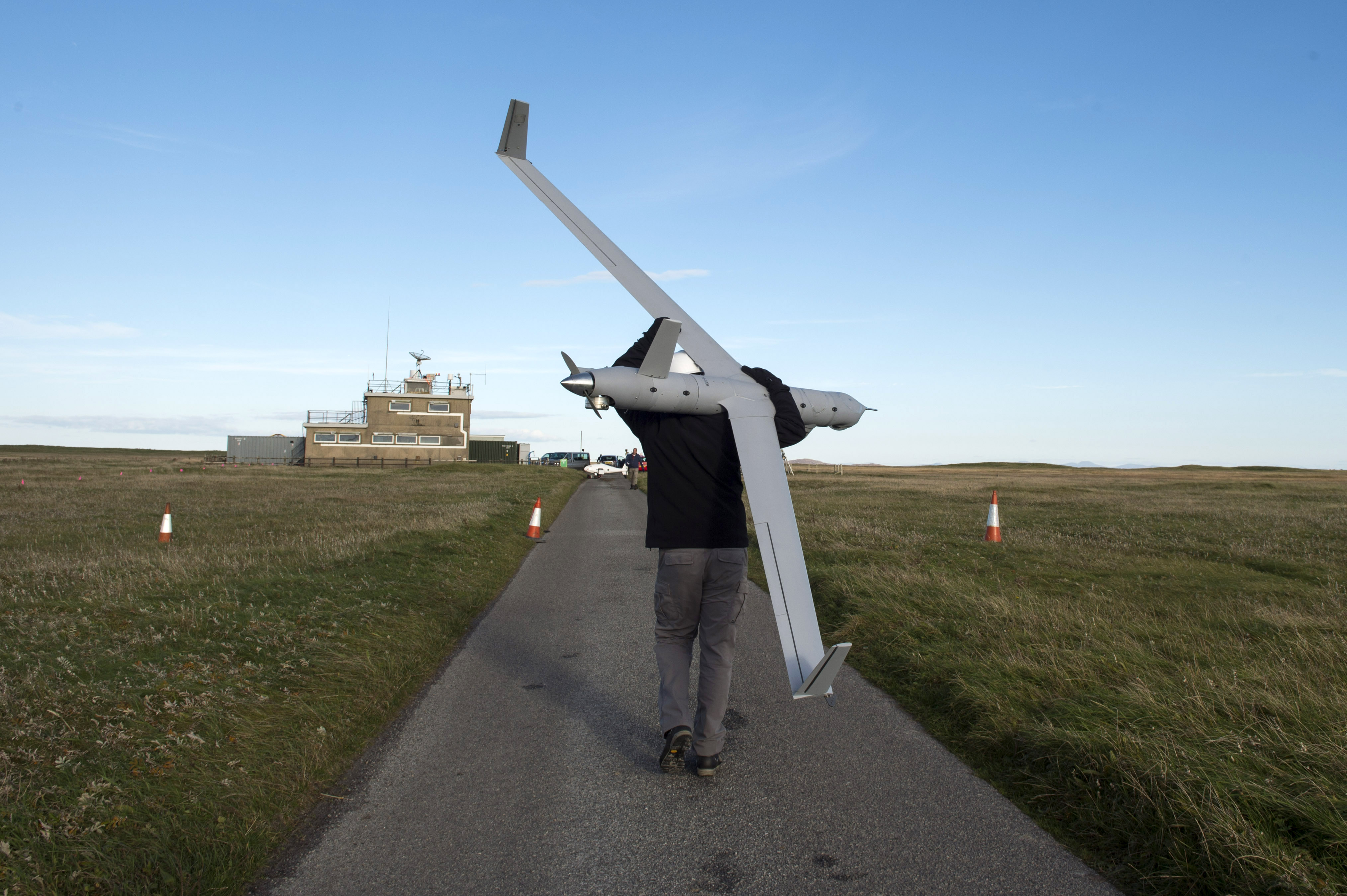 Scott Wiltermood, INSITU demonstration team manager, carries an MQ-27A Scan Eagle unmanned aerial vehicle after landing at Benbecula Rangehead on Oct. 10, 2016. More than 40 international participants from other navies, industry, academia and research laboratories are in Scotland conducting the first-ever Unmanned Warrior, a research and training exercise designed to test and demonstrate the latest in autonomous naval technologies while simultaneously strengthening international interoperability. Unmanned Warrior is part of Joint Warrior, a semiannual United Kingdom-led training exercise designed to provide NATO and allied forces with a unique multi-warfare environment in which to prepare for global operations. US Navy photo.