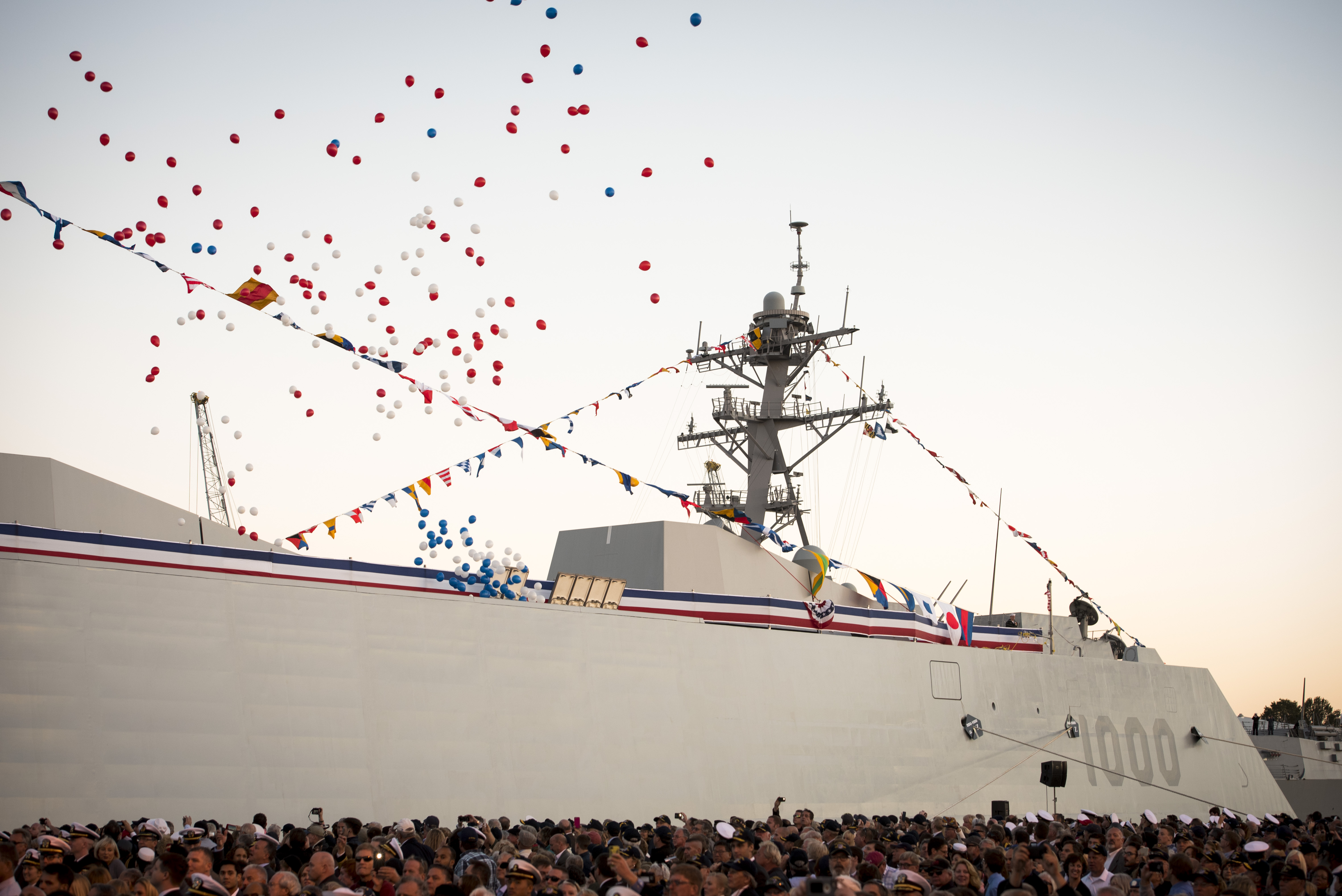 Balloons fly and the crowd applauds as the Navy's newest and most technologically advanced warship, USS Zumwalt (DDG 1000), is brought to life during a commissioning ceremony at North Locust Point in Baltimore. US Navy photo.