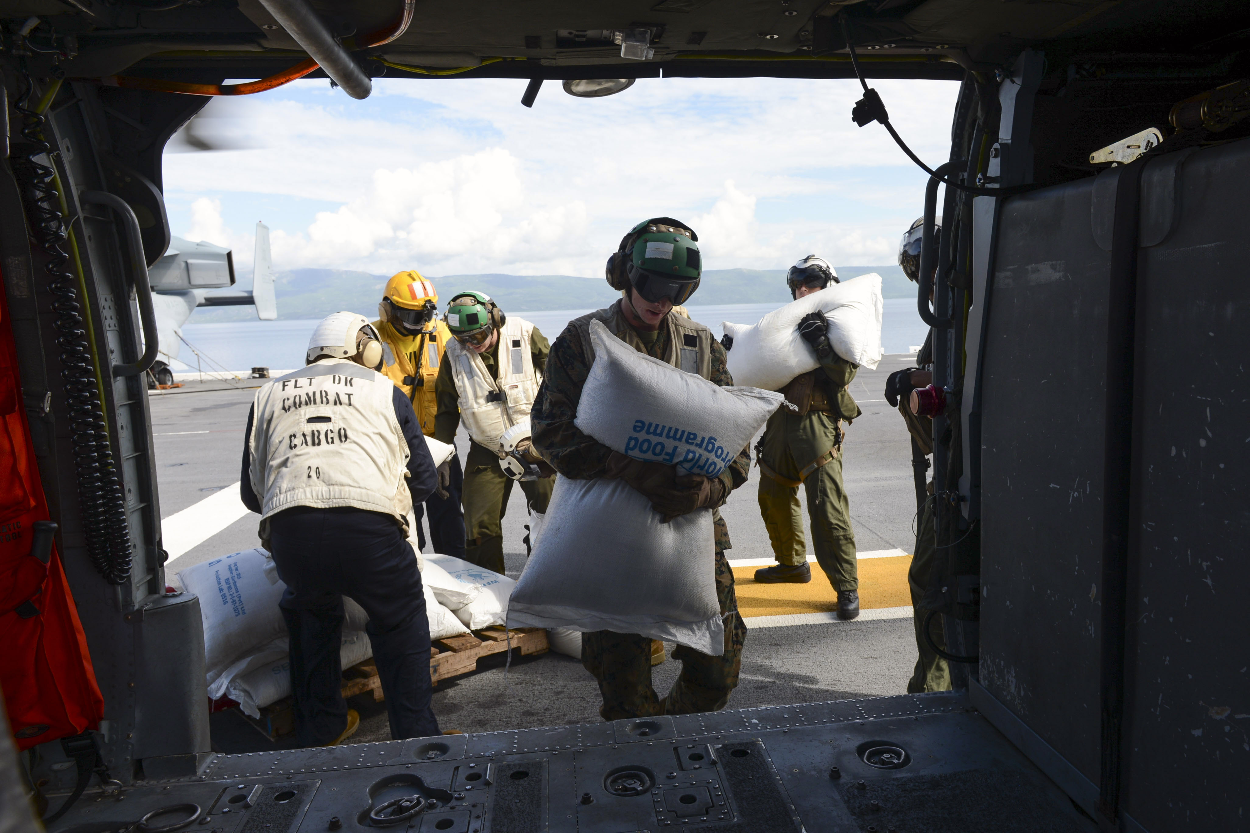 Sailors and Marines attached to Joint Task Force (JTF) Matthew load food for delivery onto an MH-60S Knighthawk, assigned to Helicopter Sea Combat Squadron 28 (HSC-28), aboard amphibious assault ship USS Iwo Jima (LHD 7) on Oct. 18. US Navy photo.